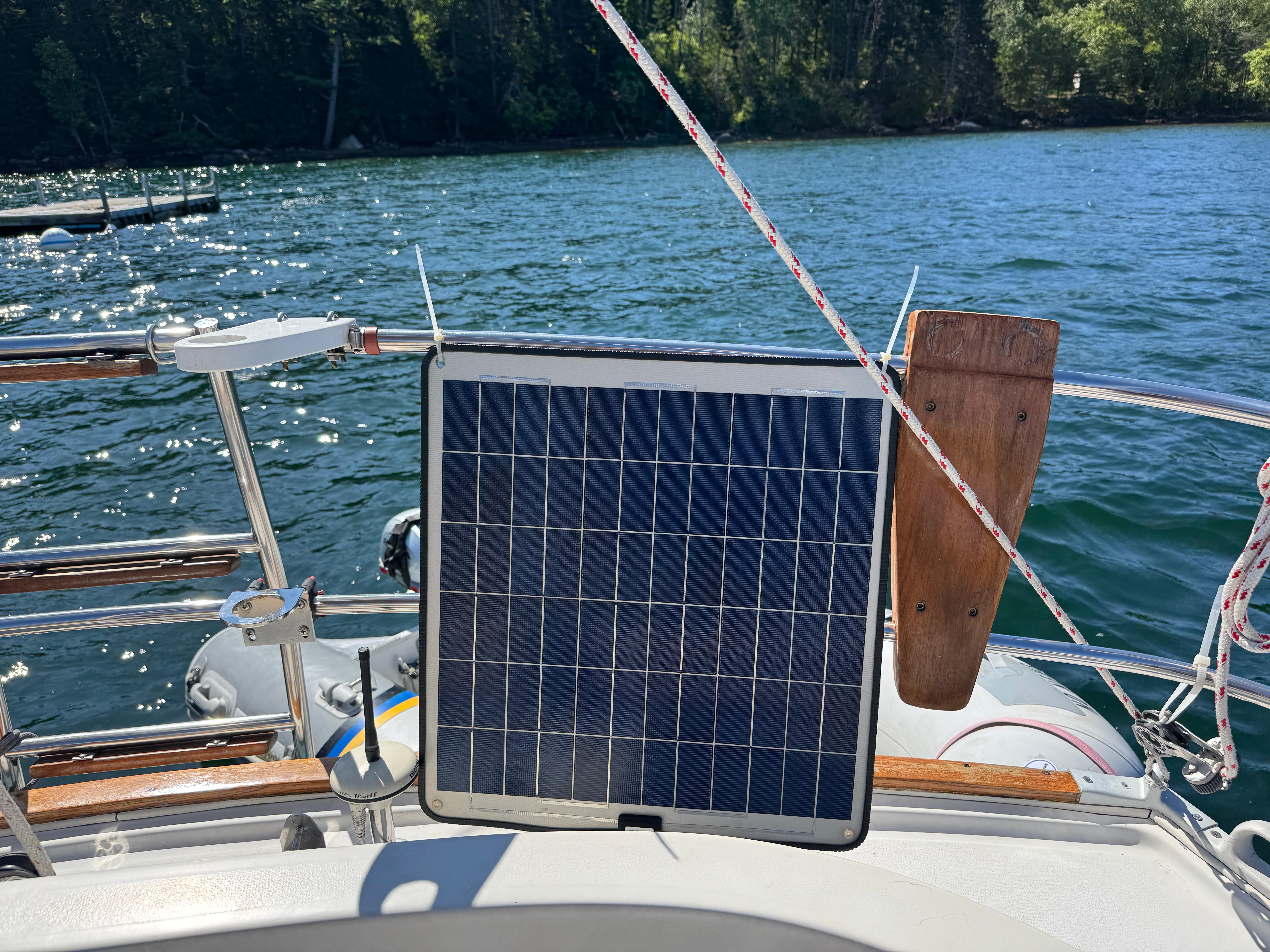 Solar panel on 1989 Nonsuch 30 Ultra sailboat, lake view in background.