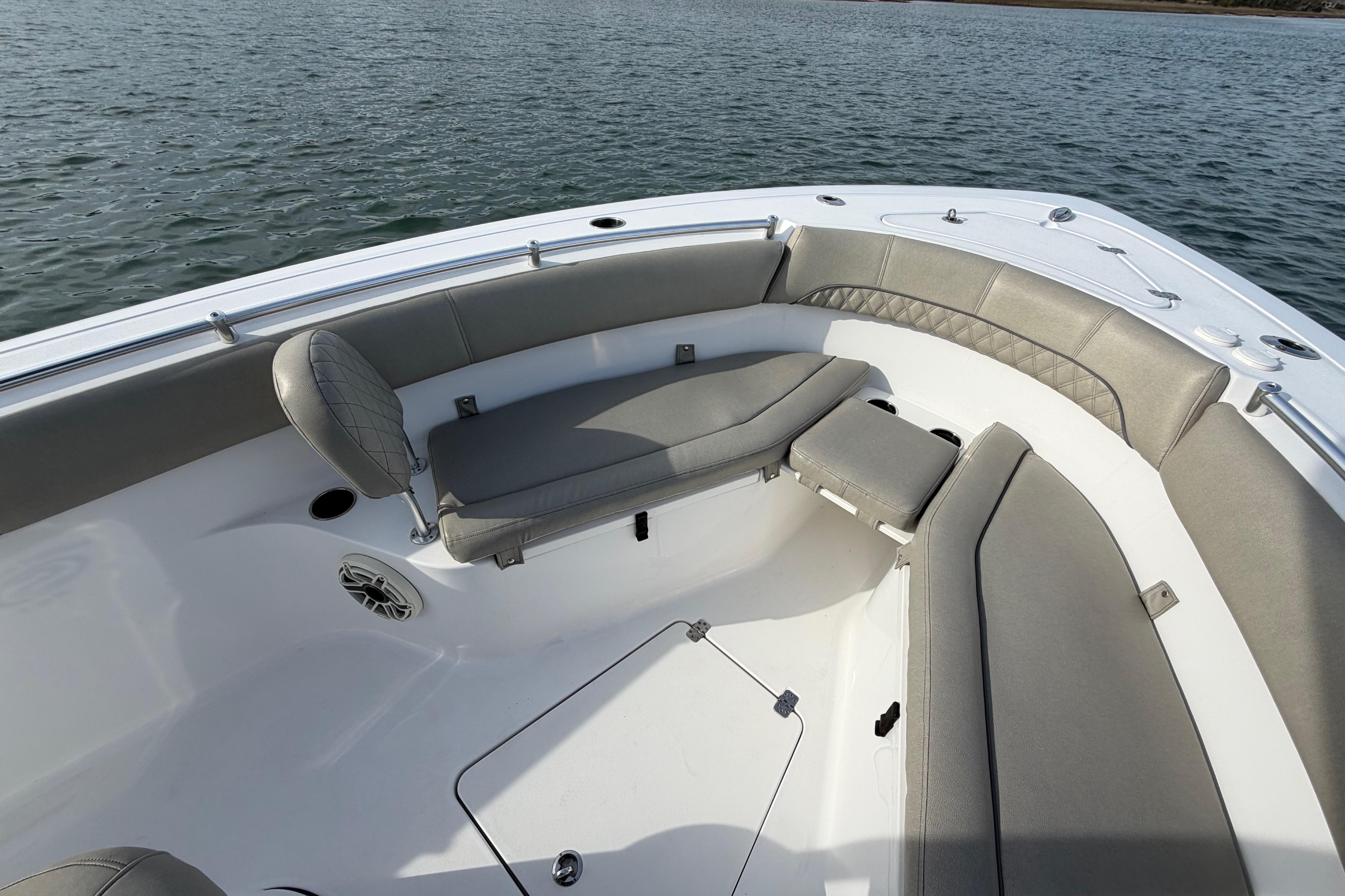 2021 Sportsman Heritage 251 Center Console boat with spacious seating on calm water.