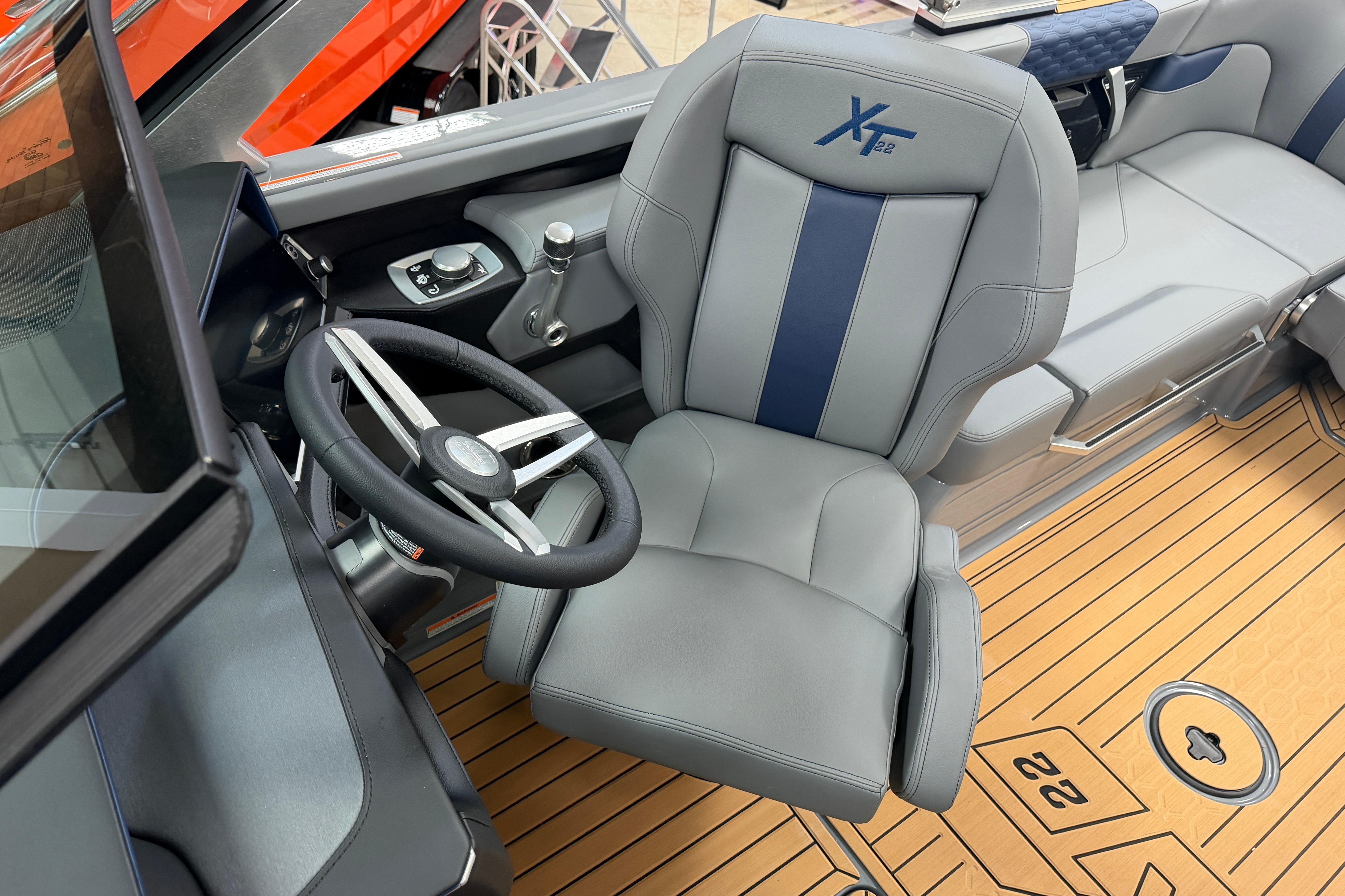 2026 MasterCraft XT22 boat interior with steering wheel and captain's seat.