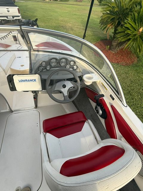 Interior of a 2012 Bayliner 184 SF with red and white seating.