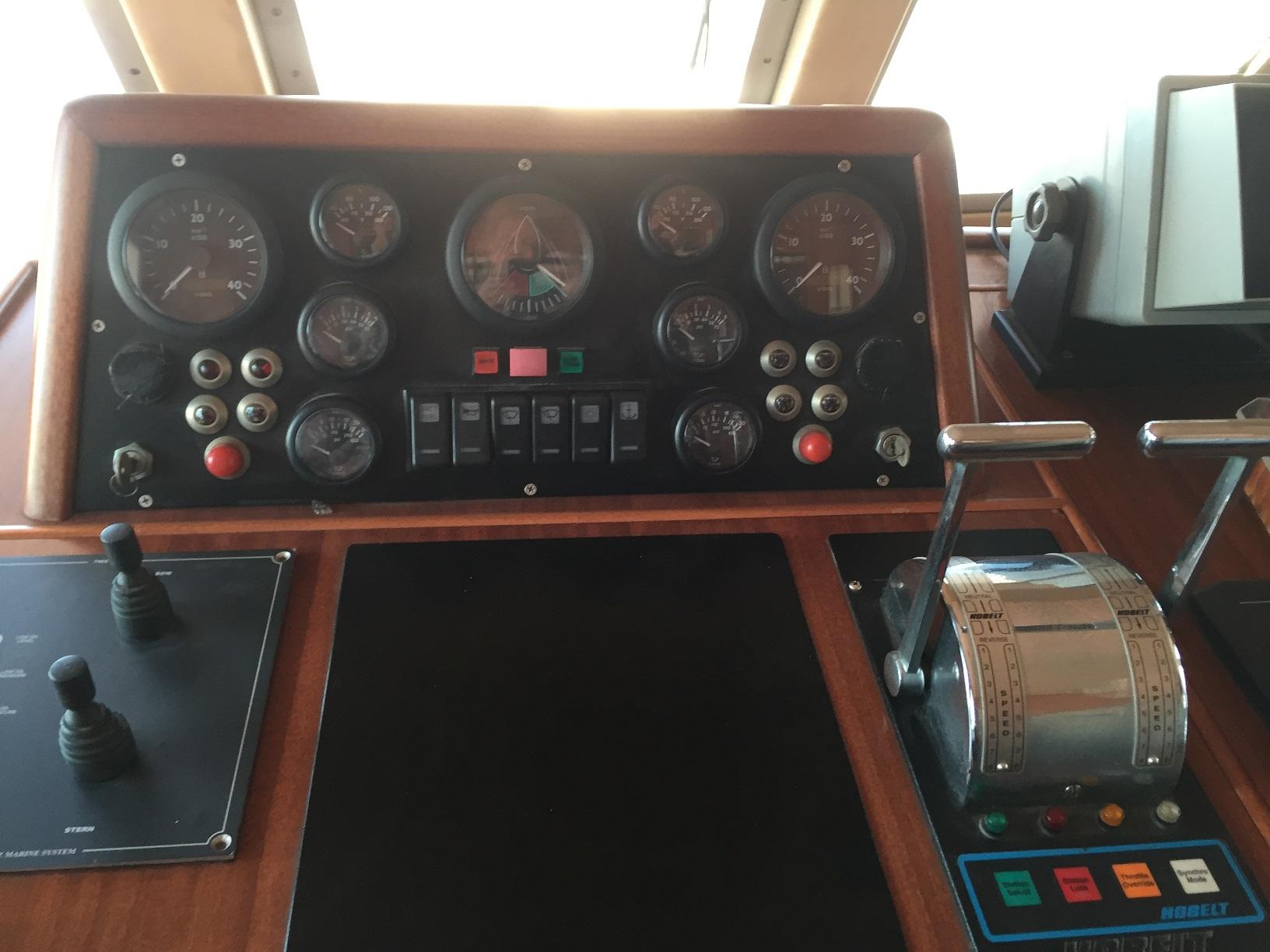 Control panel of a 1969 Benetti 24 yacht, featuring gauges and levers.