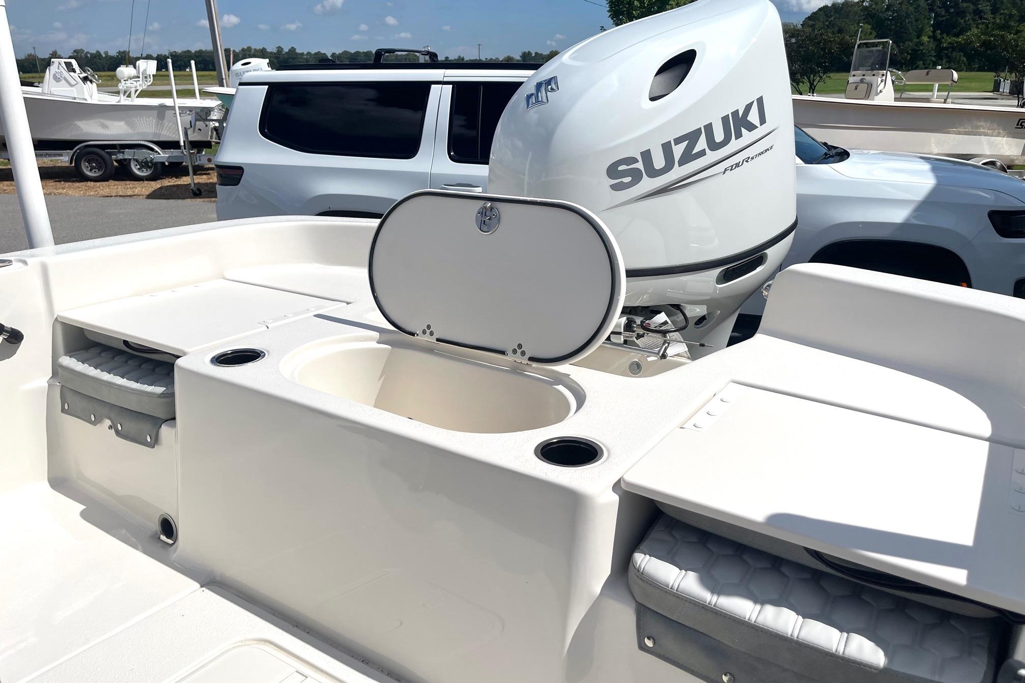 2026 Carolina Skiff 19 LS boat with Suzuki outboard motor, featuring storage compartments.