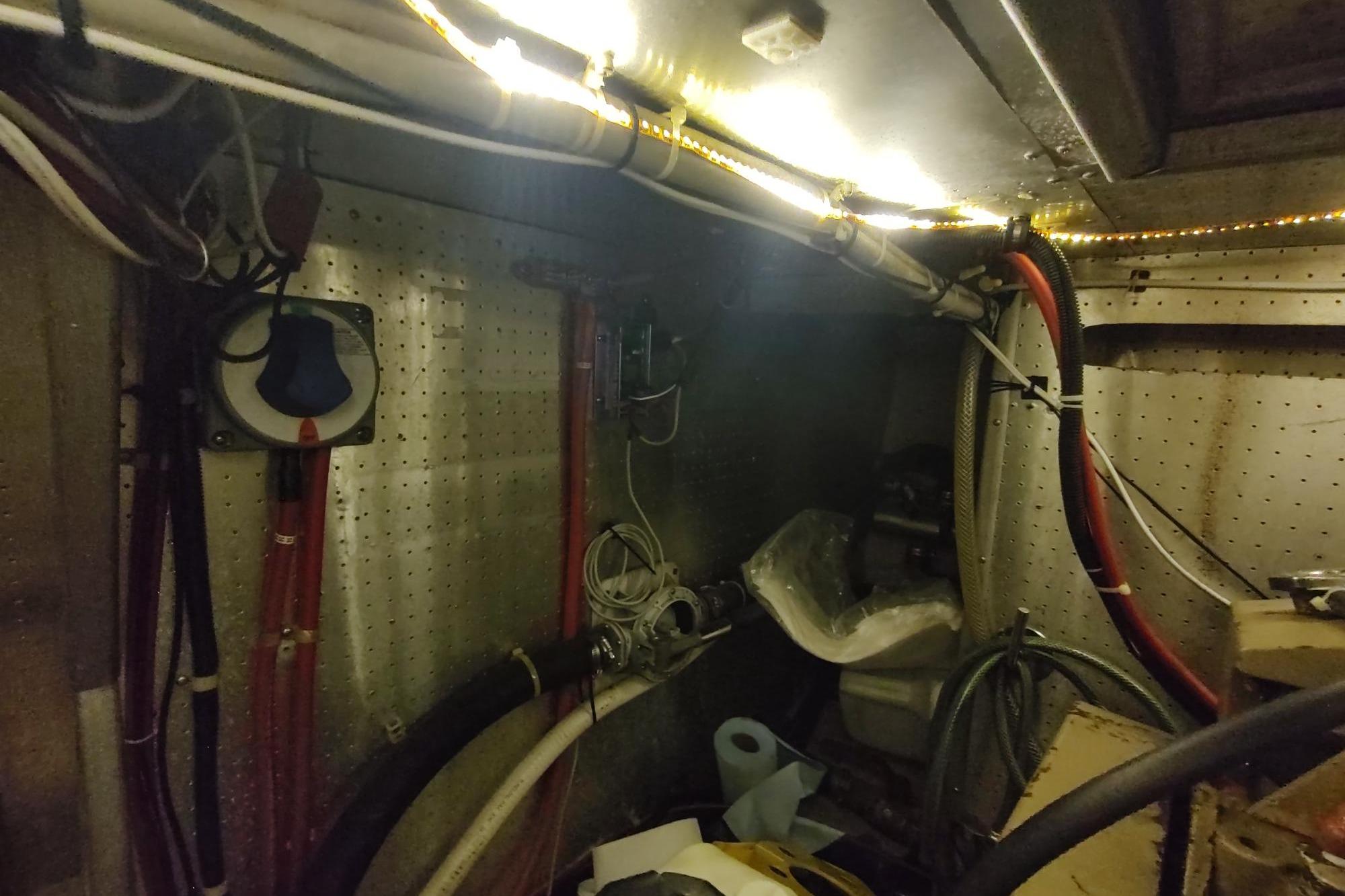 Engine room of a 1989 Hyatt Double Cabin Motoryacht with visible wiring and equipment.