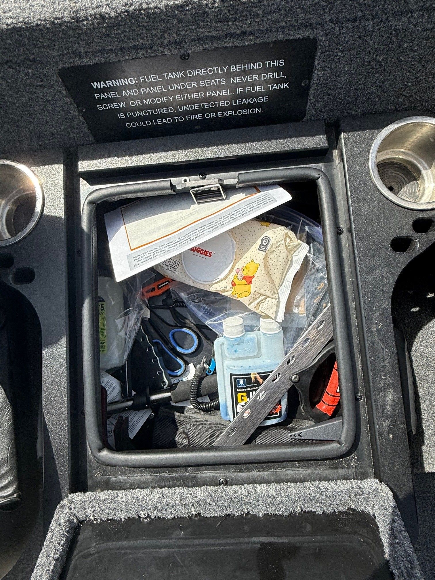 Storage compartment in Phoenix 721 ZXL boat with tools and accessories, year 2025.