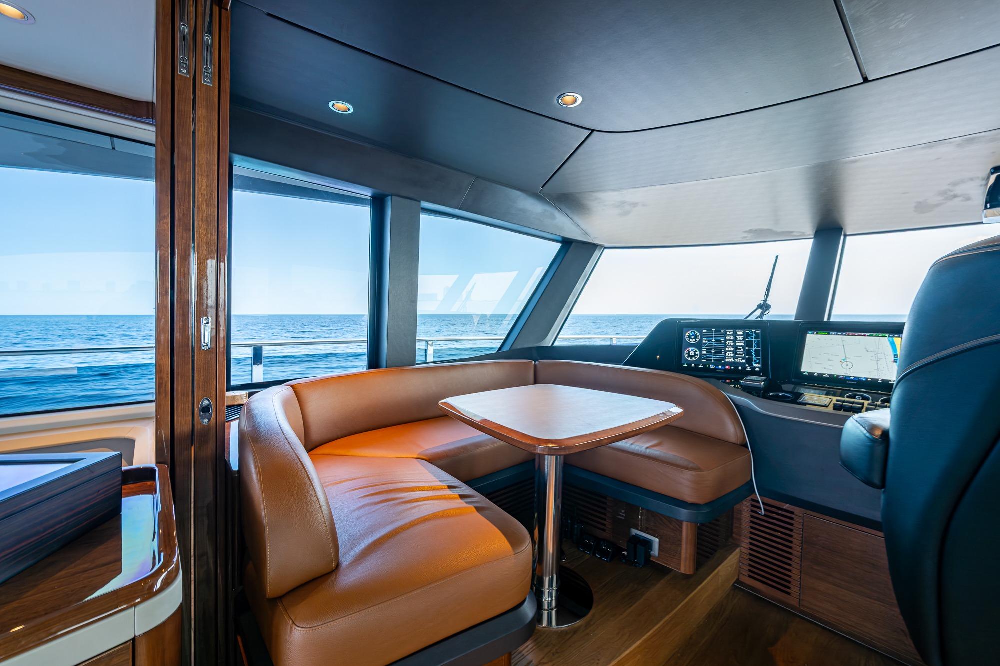 Luxurious interior of 2022 Princess X95 yacht with ocean view and navigation system.