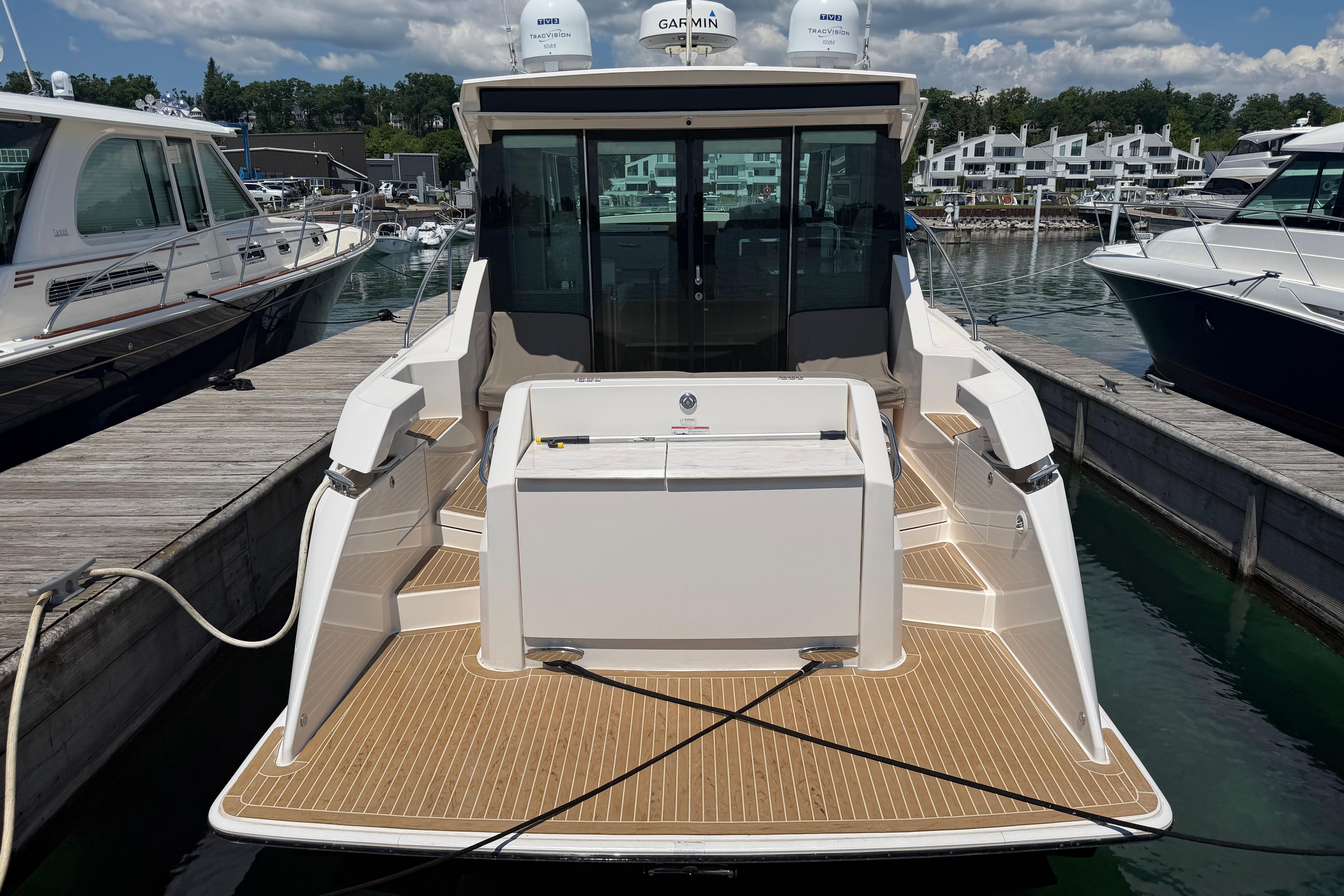 2016 Tiara Yachts C39 Coupe docked at marina, rear view.