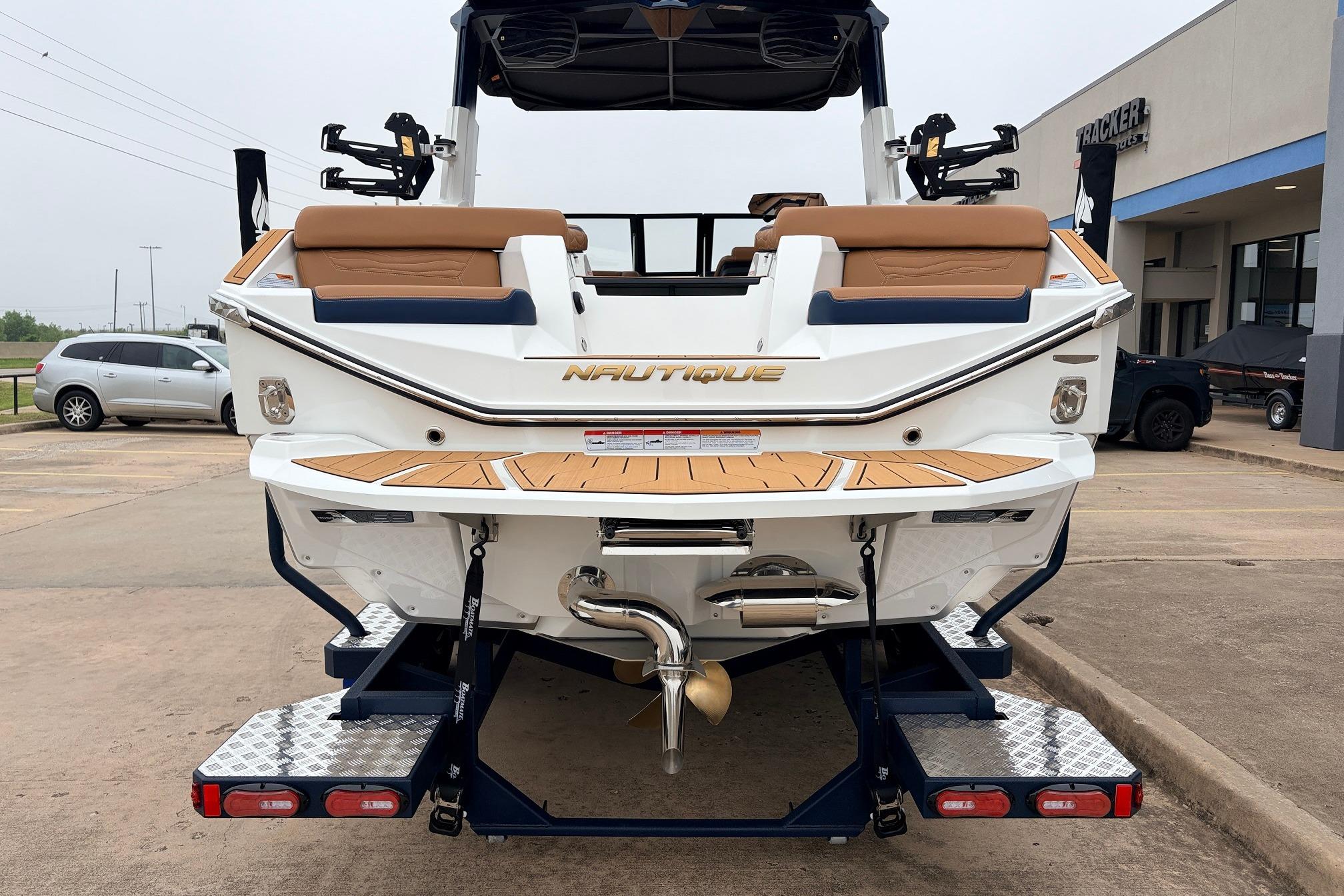 2026 Nautique Super Air Nautique G25 boat rear view in a parking lot.