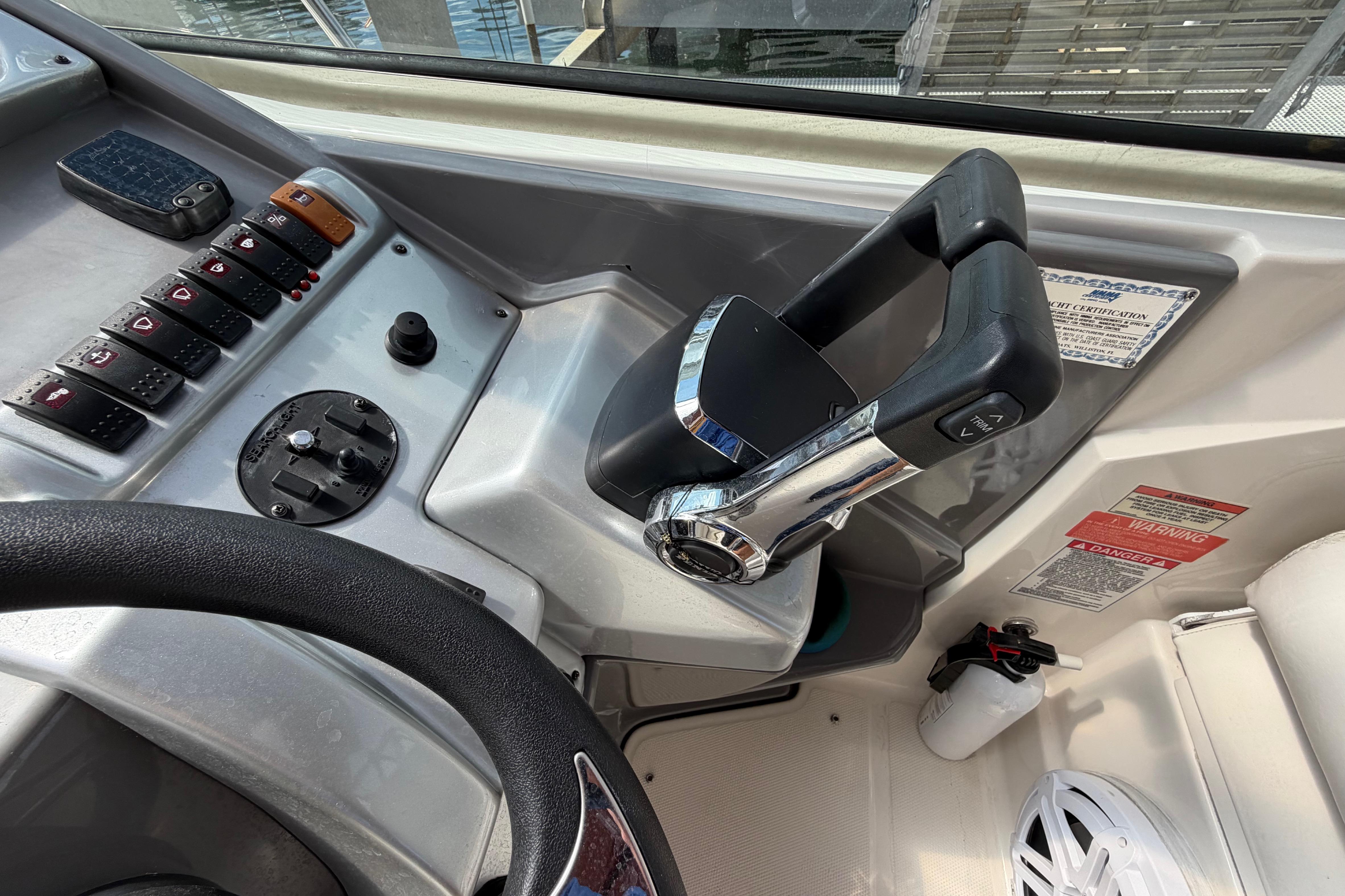 Control panel of a 2007 Monterey 350 Sport Yacht with throttle and switches.