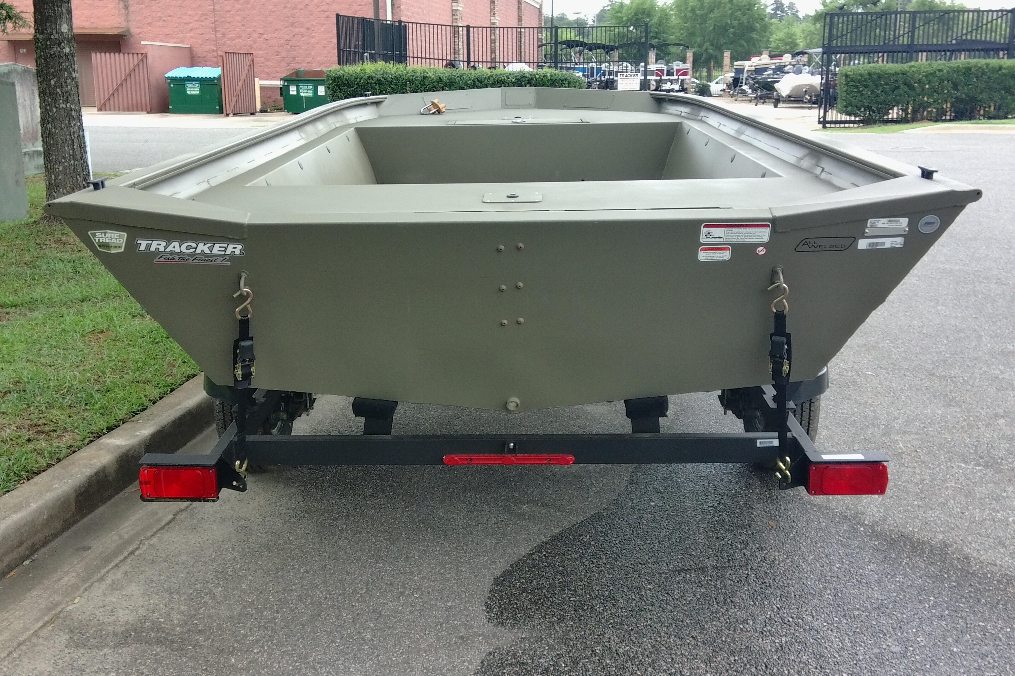 2026 Tracker Grizzly 1860 Utility boat on trailer, parked outdoors.