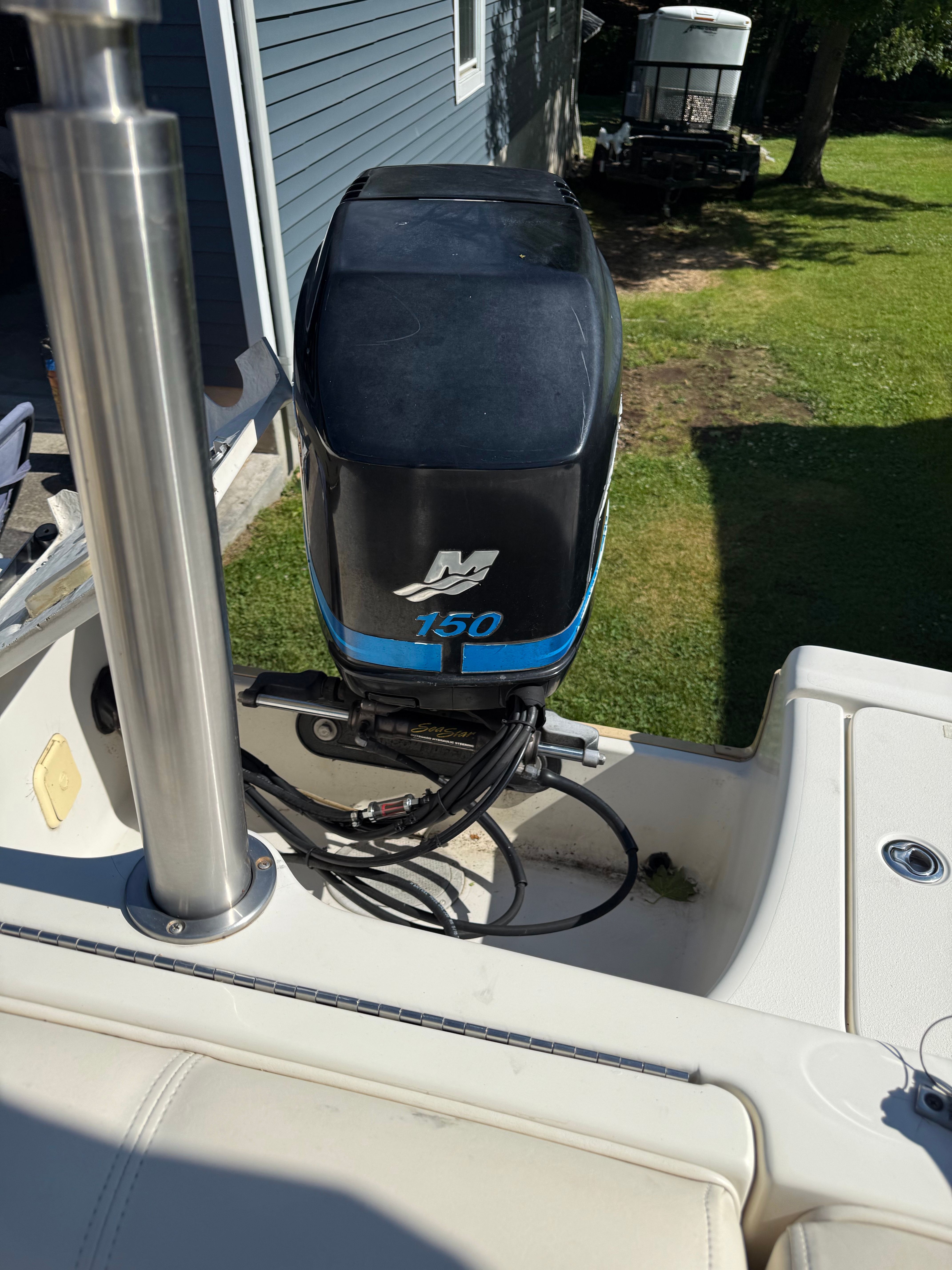 A boat engine labeled "150" is mounted on a boat.