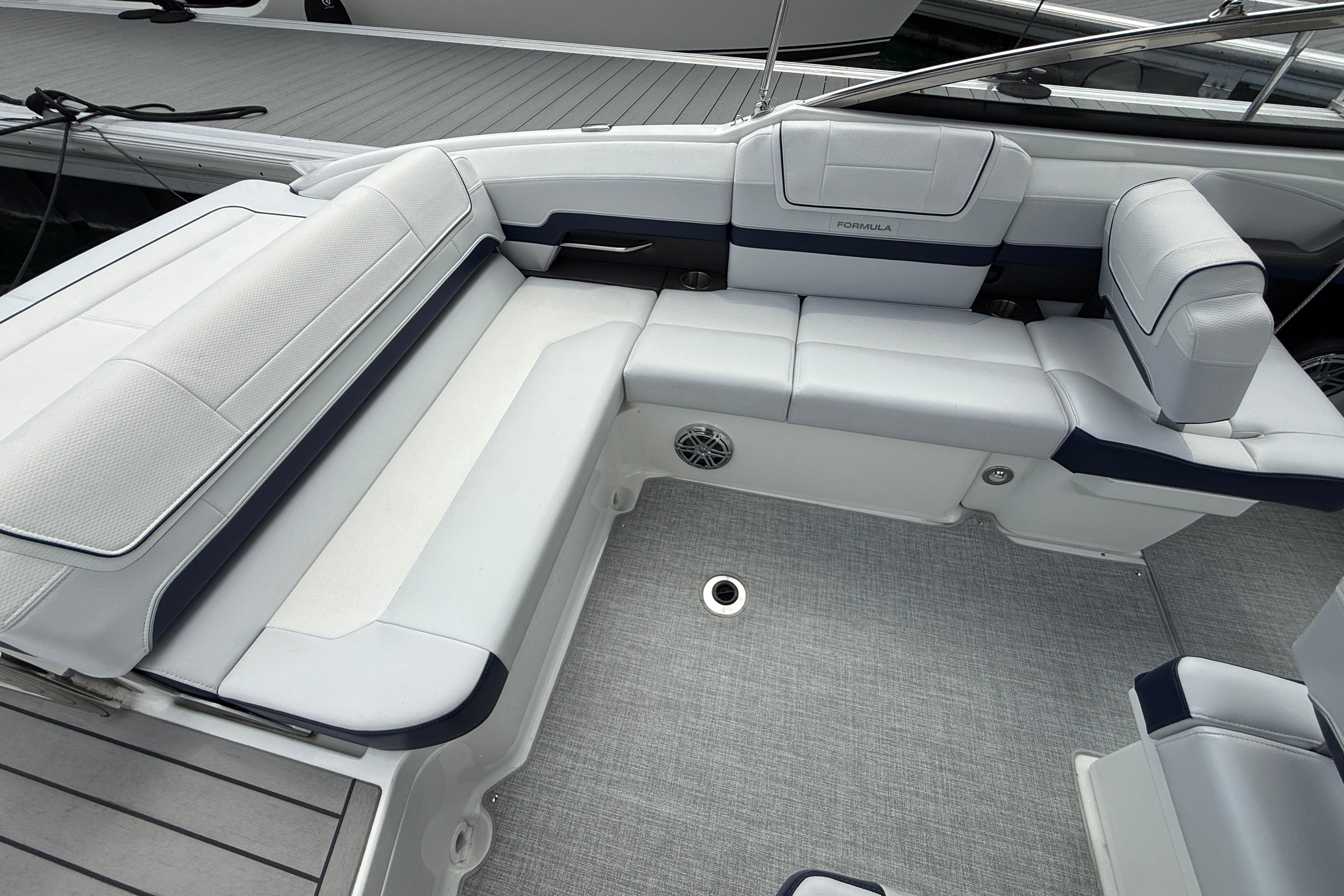 2024 Formula 270 Bowrider interior with white and navy seating, docked at marina.