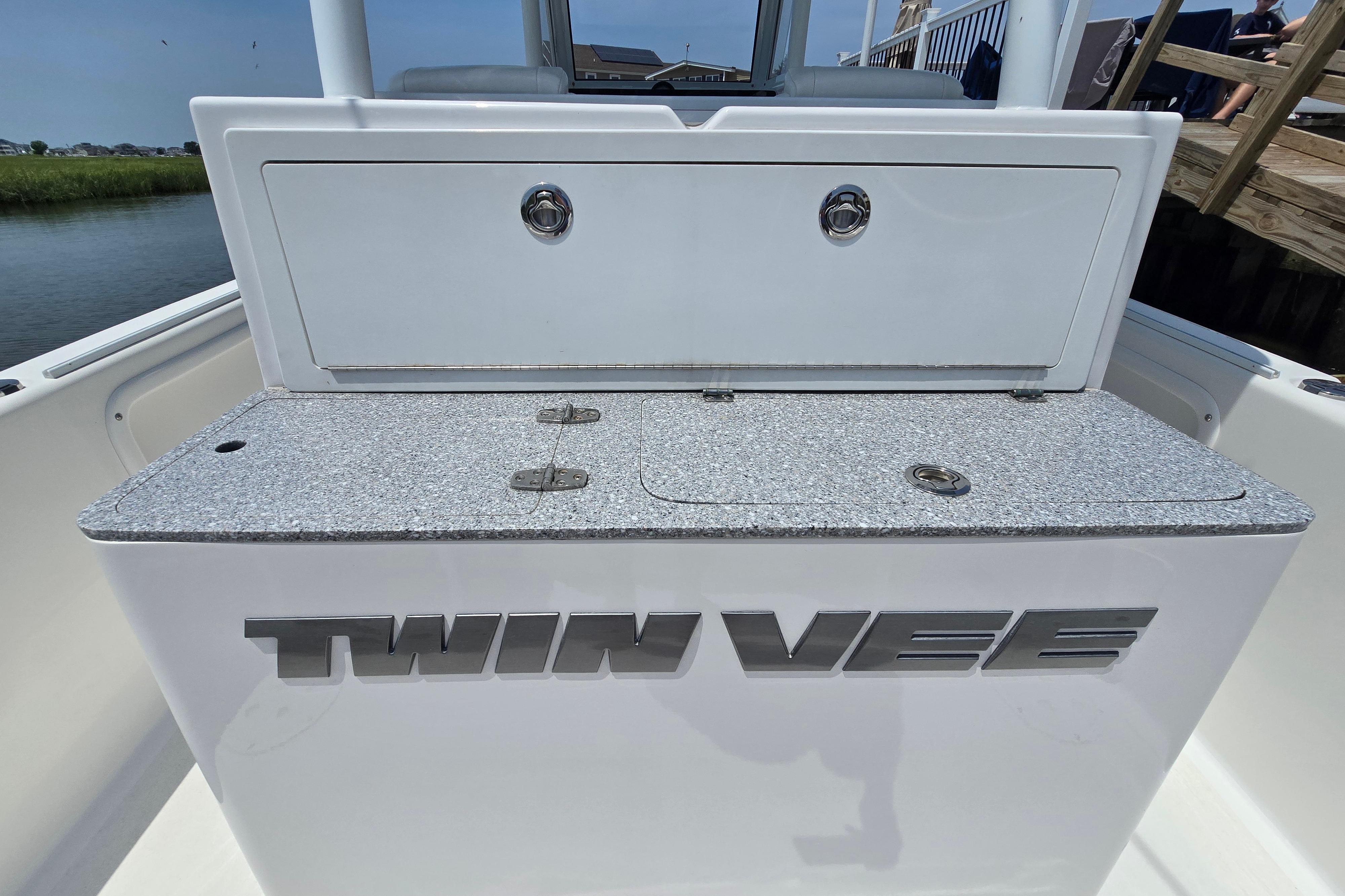 2021 Twin Vee 280 GFX CC boat interior with storage compartment and logo.