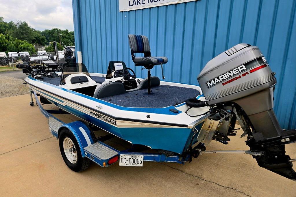 1996 Champion 181 SX boat with Mariner outboard motor, parked on a trailer.