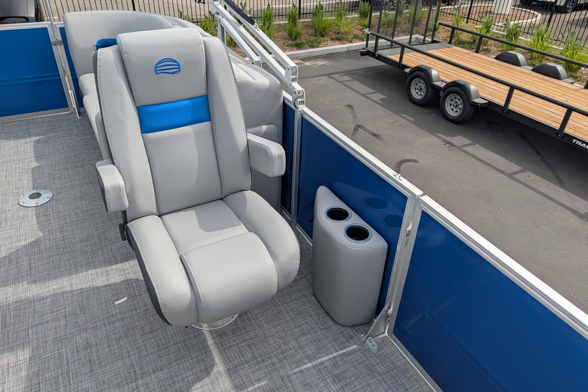 2026 Sun Tracker Party Barge 22 DLX with plush seating and cup holders on deck.