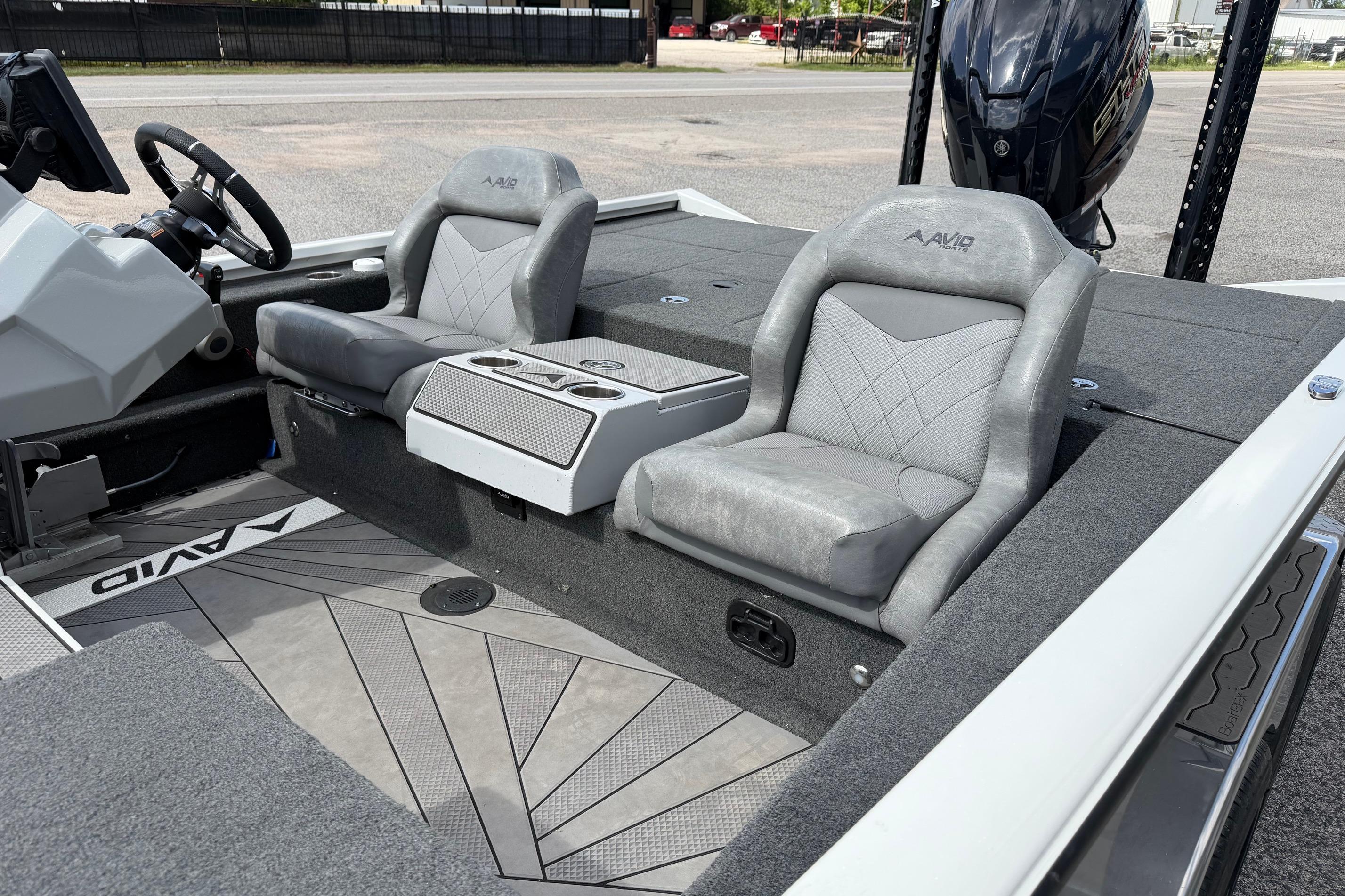 2024 Avid 21 XB Elite boat interior with gray seating and steering wheel.
