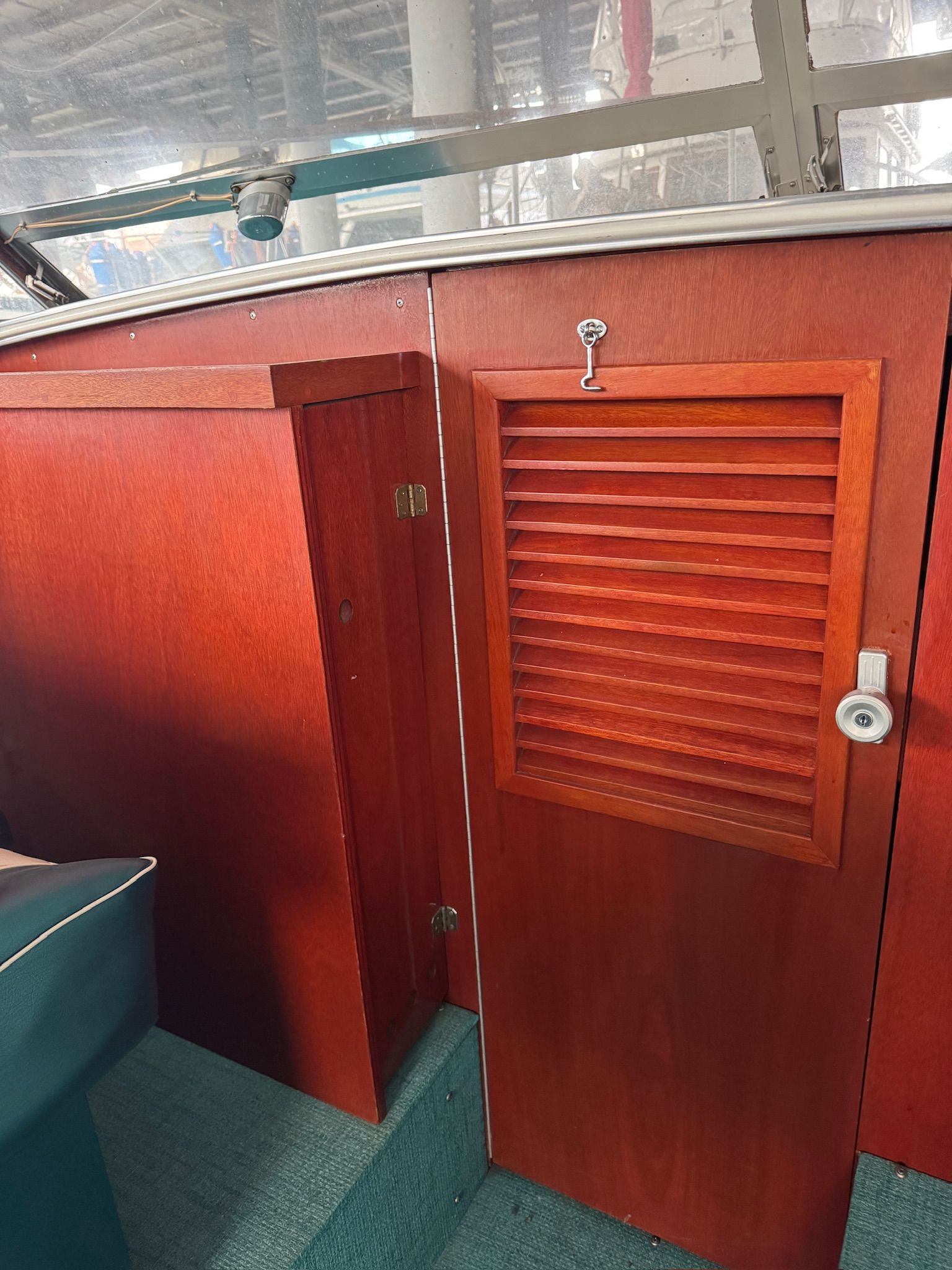 Interior of a 1972 Skiff Craft Hardtop with wooden doors and green carpeting.