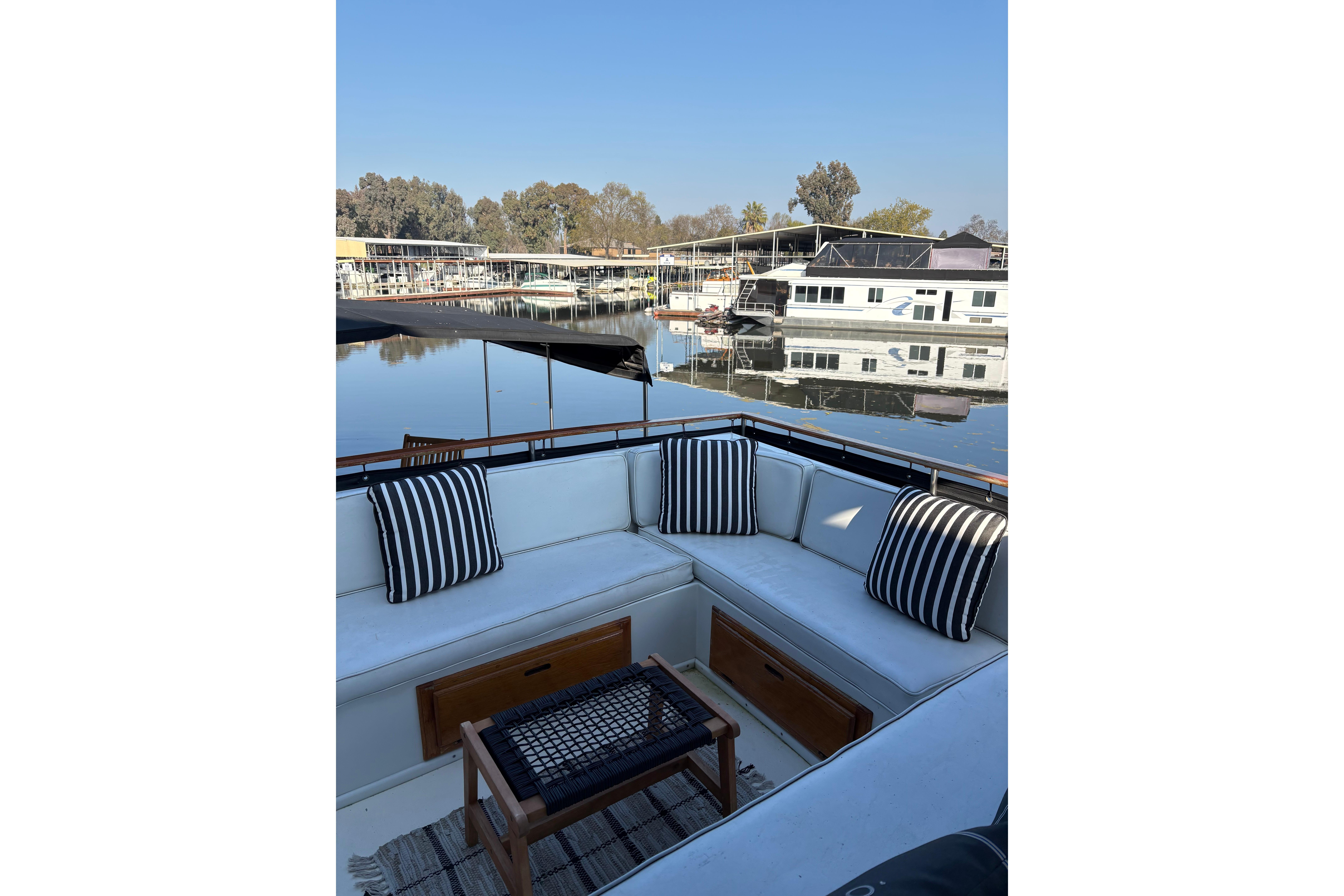 1978 Californian 42 LRC yacht with striped cushions, docked in a serene marina setting.