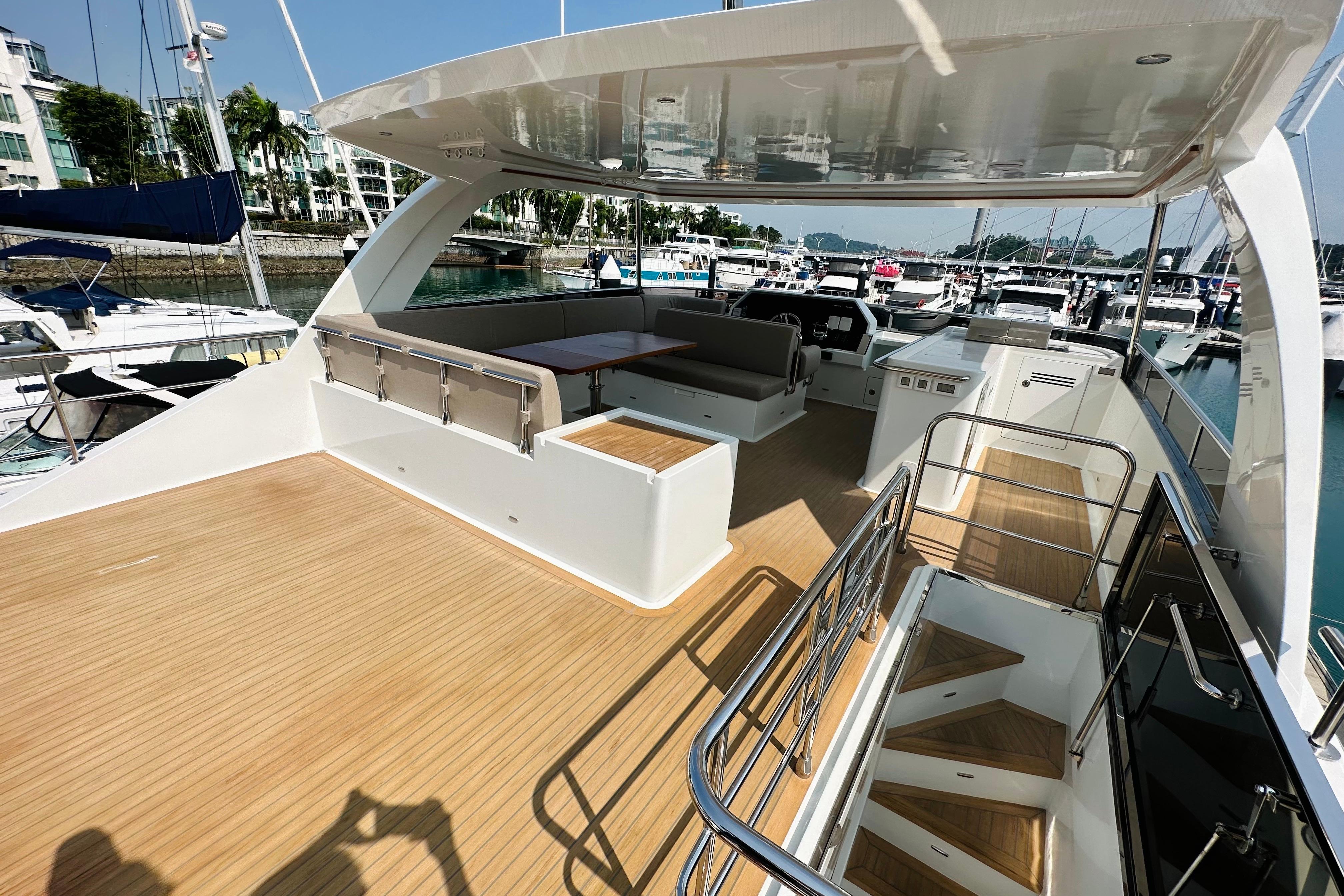 Luxurious 2022 ILIAD 50 yacht deck with seating area, docked at marina.