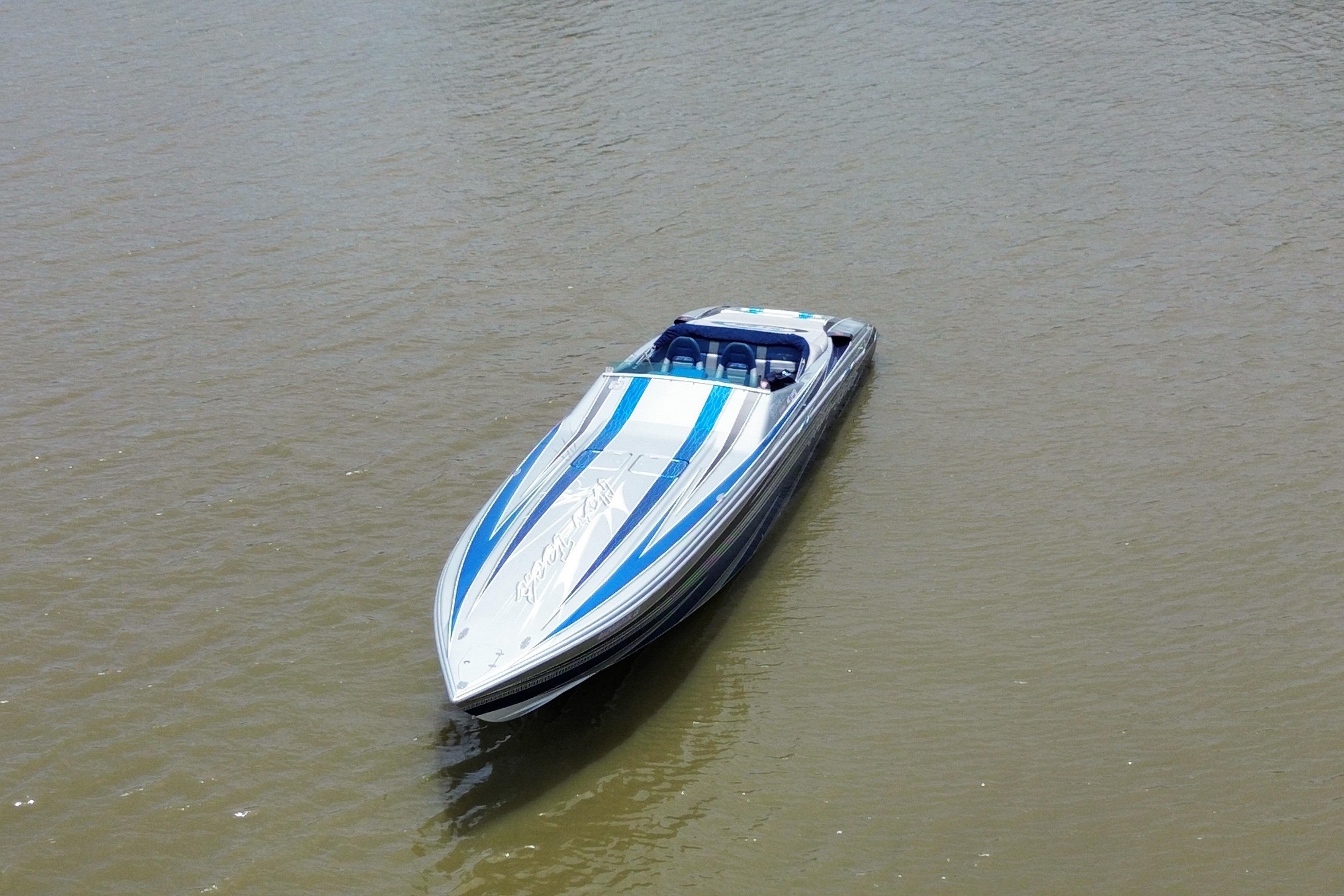 2013 Nor-Tech 477 SPX Vee Bottom boat with blue and white design on calm water.
