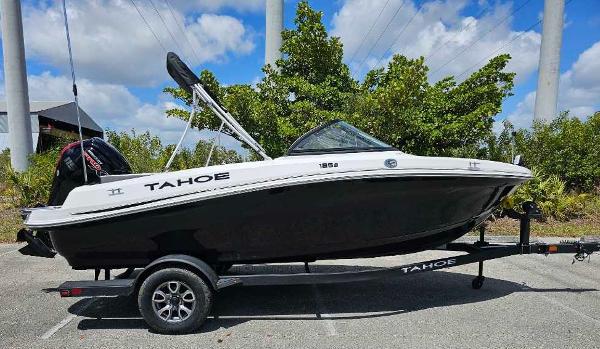 2025 Tahoe 185 S boat on trailer, parked outdoors under a blue sky.