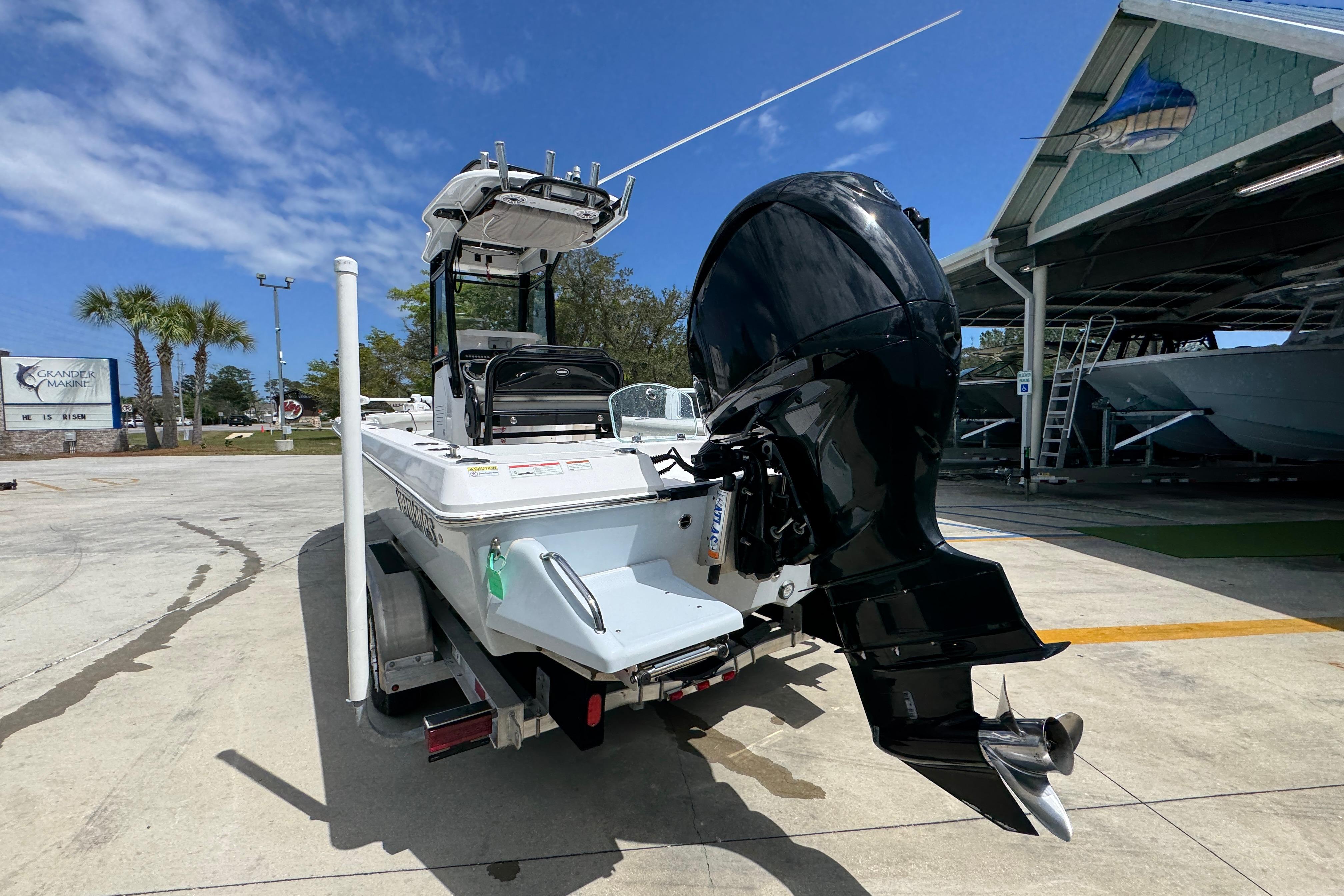 2022 Everglades 243 Center Console boat with powerful outboard motor at marina.