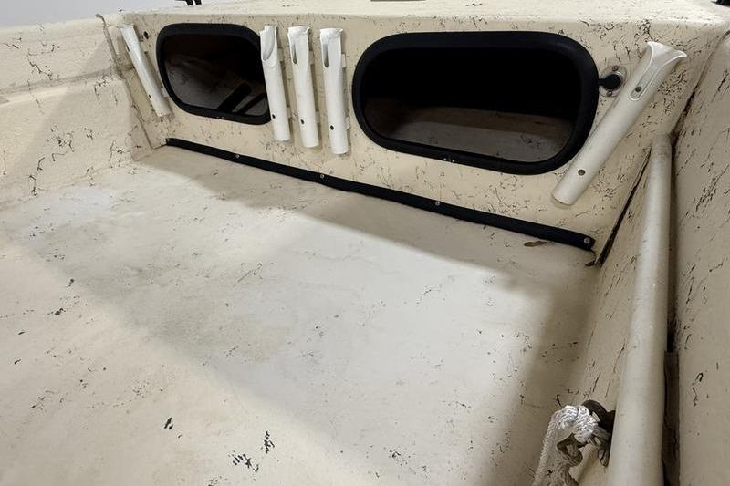1998 Carolina Skiff 1965 V interior with rod holders and storage compartments.