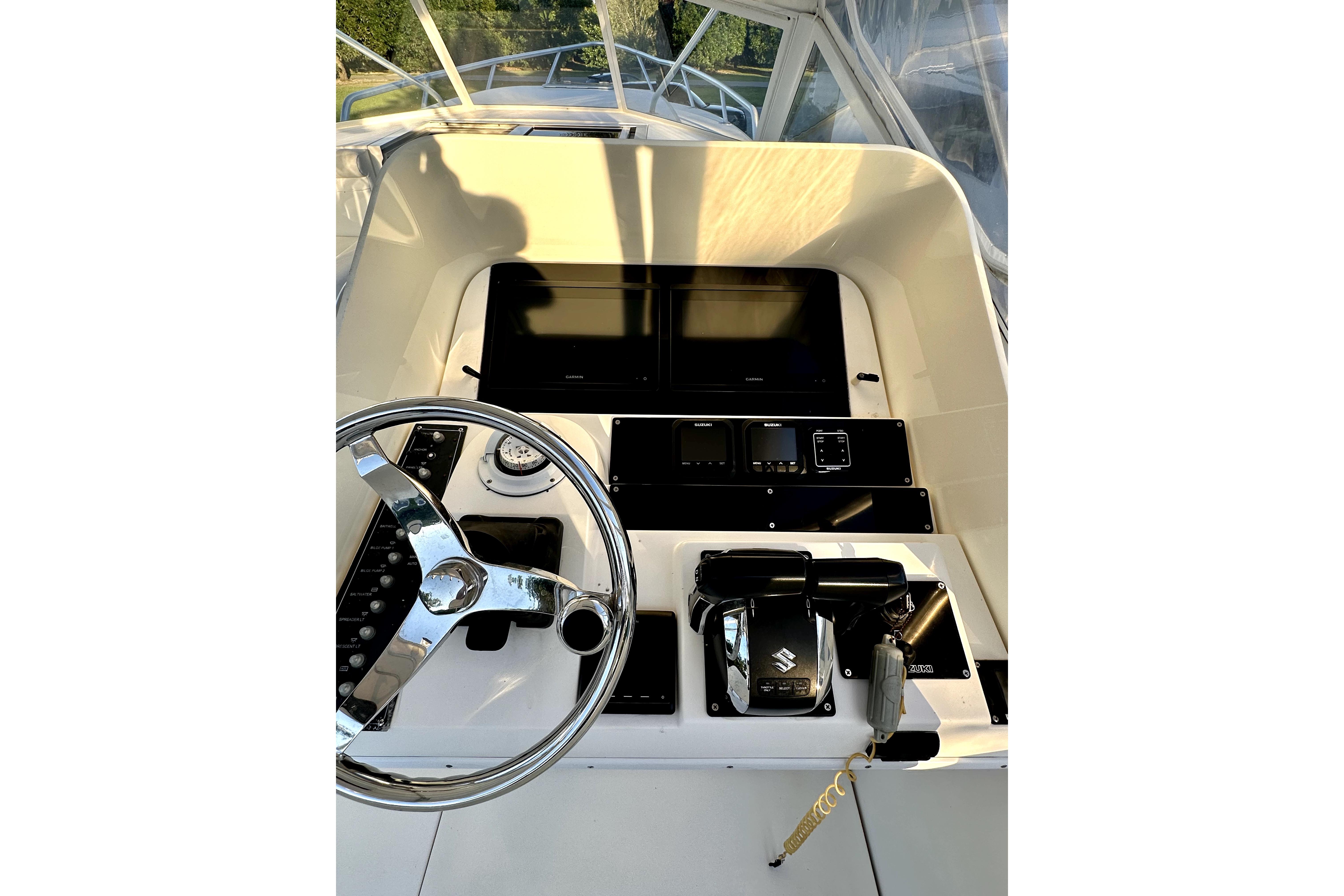 2006 Contender 35 Express Side Console helm with steering wheel and control panel.