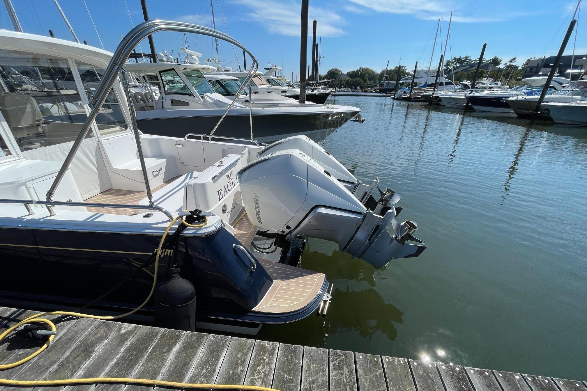 2023 MJM 35 boat docked with dual outboard engines in a marina.