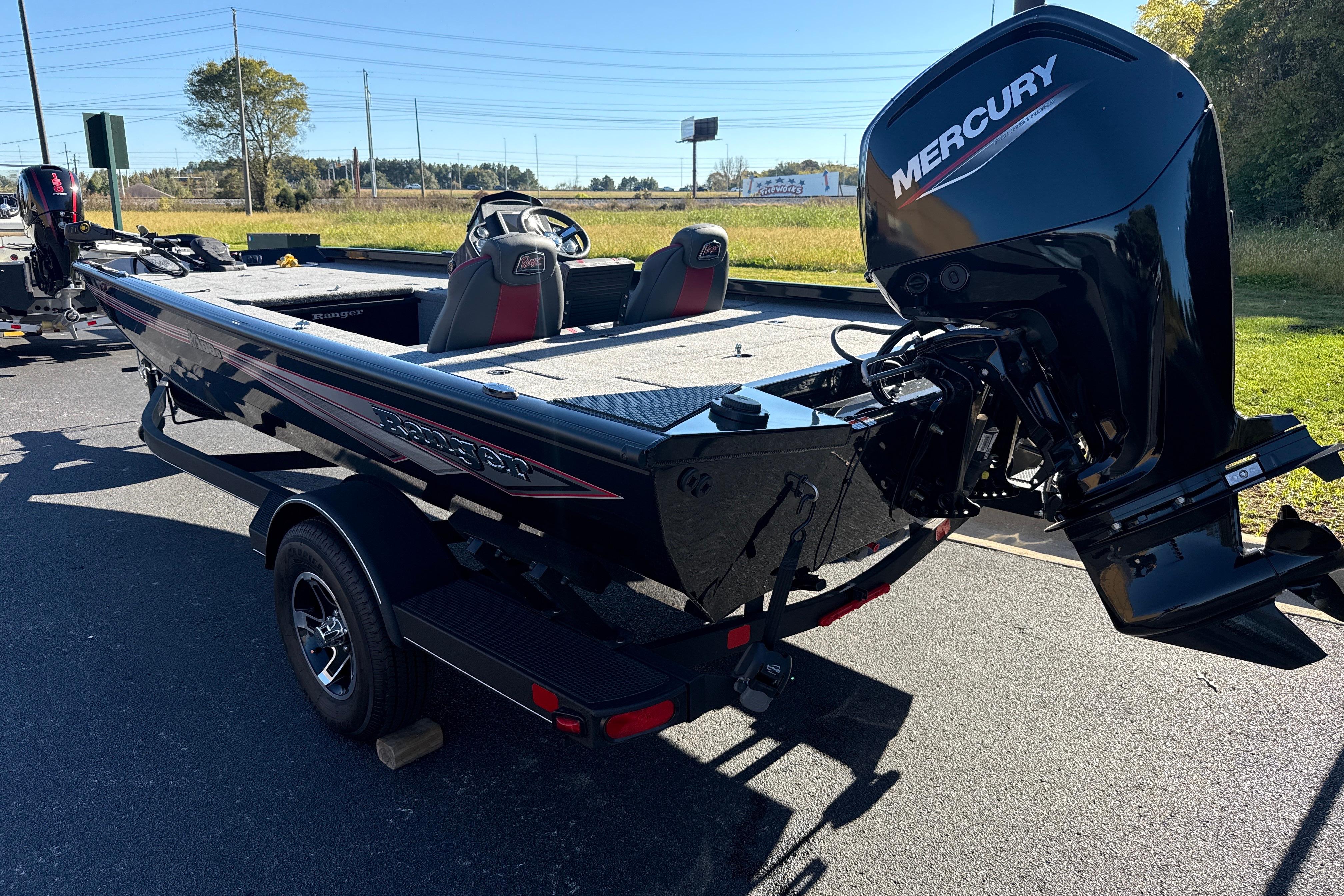 2025 Ranger RT188C boat with Mercury engine on a trailer, parked outdoors.