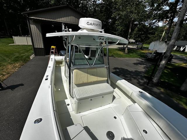 2008 Regulator 29 Forward Seating boat with Garmin equipment, parked near a garage.