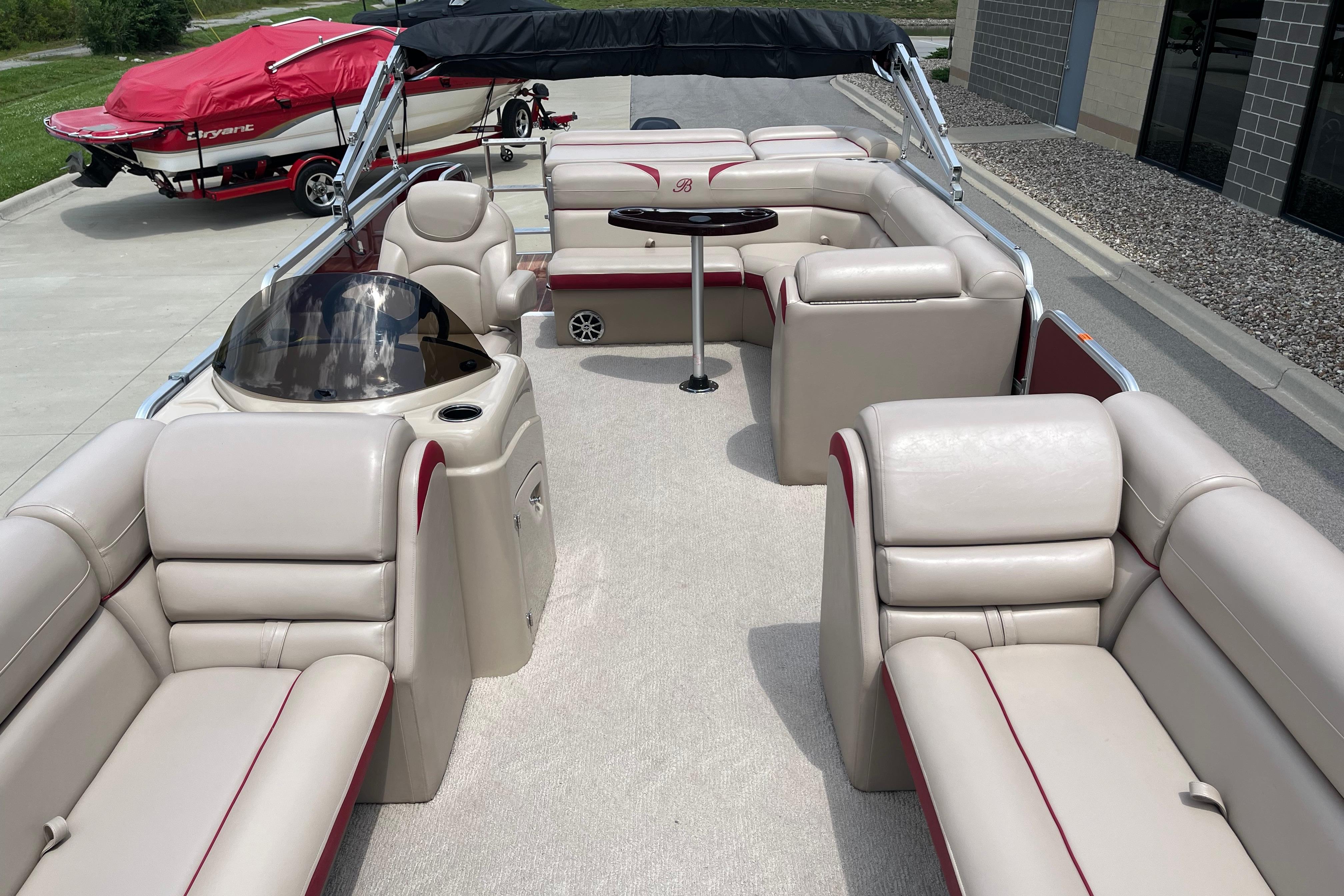 2013 Berkshire 230CL CTS pontoon boat with beige seating and a black canopy.