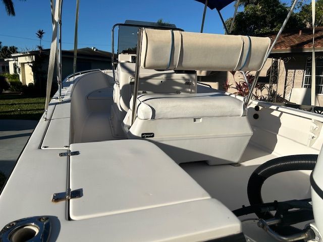 1994 Aquasport Osprey boat with white seating area outdoors.