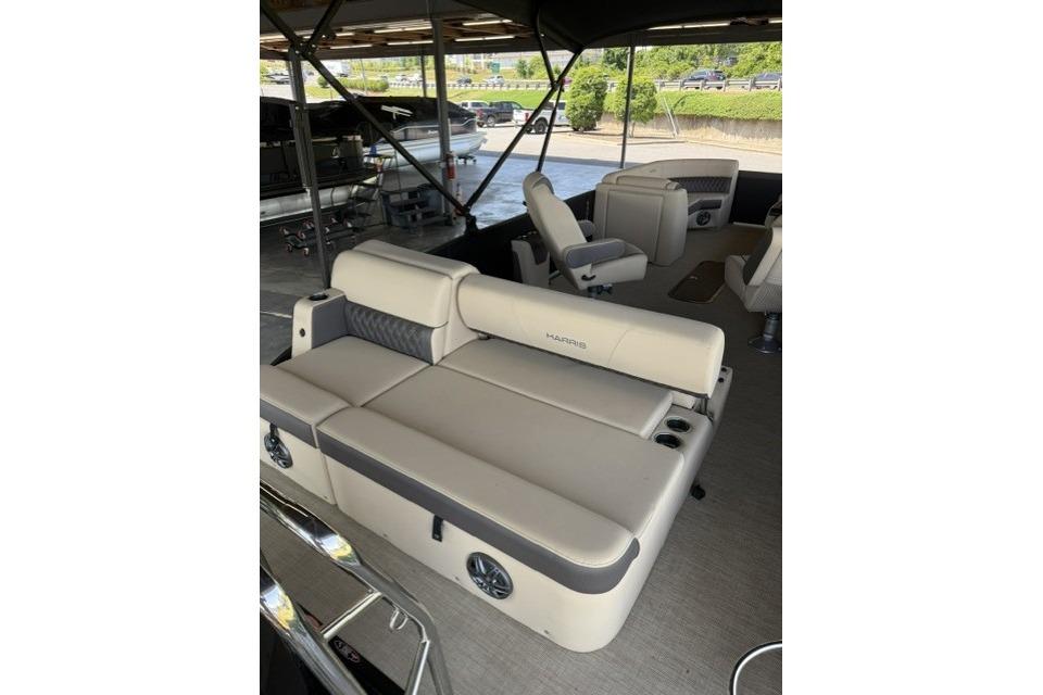 2025 Harris Sunliner 230 pontoon boat interior with beige seating and cup holders.