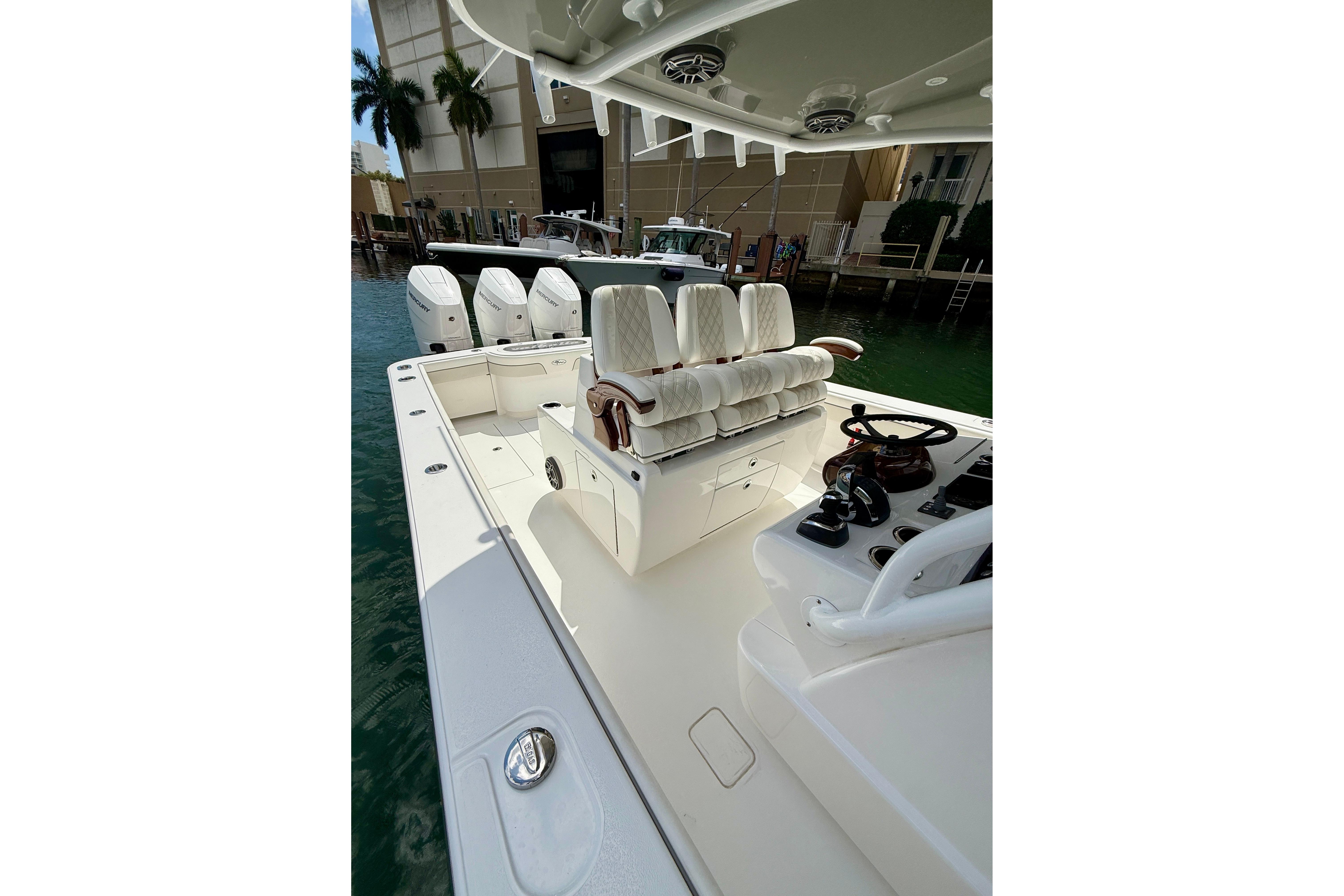 2024 Valhalla Boatworks V-37 with luxurious seating and sleek design in marina setting.