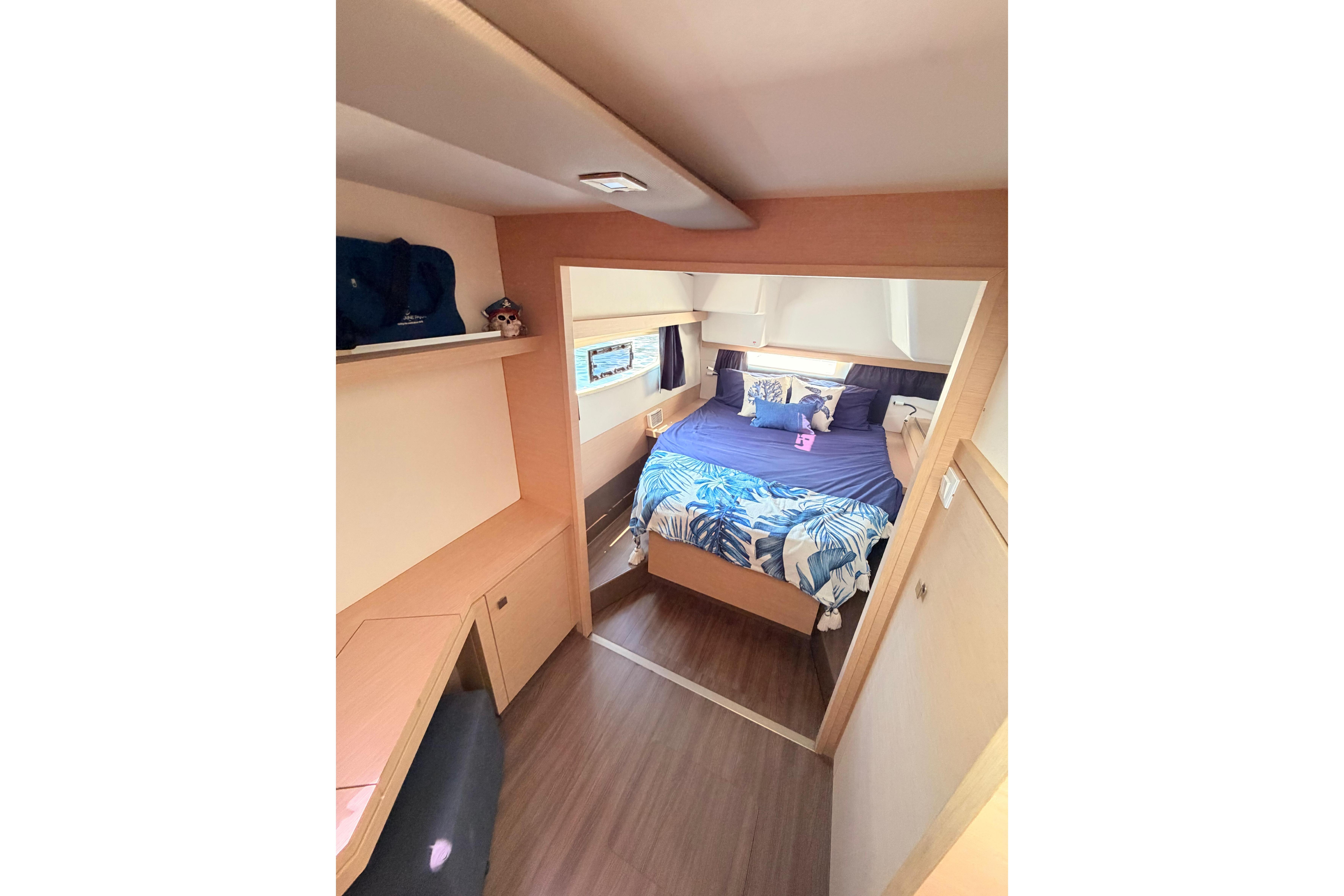 Interior cabin of 2018 Fountaine Pajot Lucia 40 catamaran with cozy bed and modern decor.