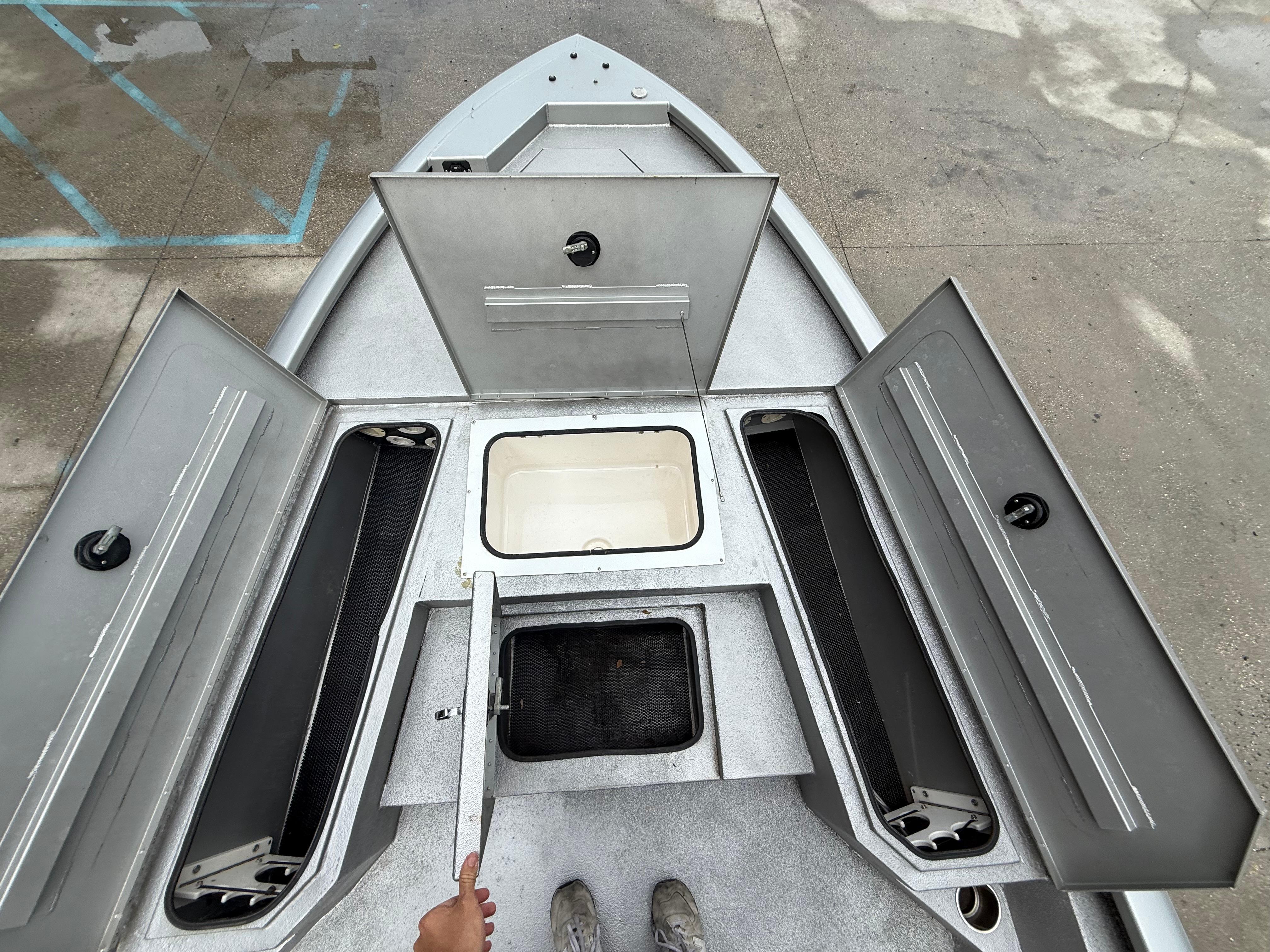 2020 Avid 23 FS Platinum boat with open storage compartments and clean deck.