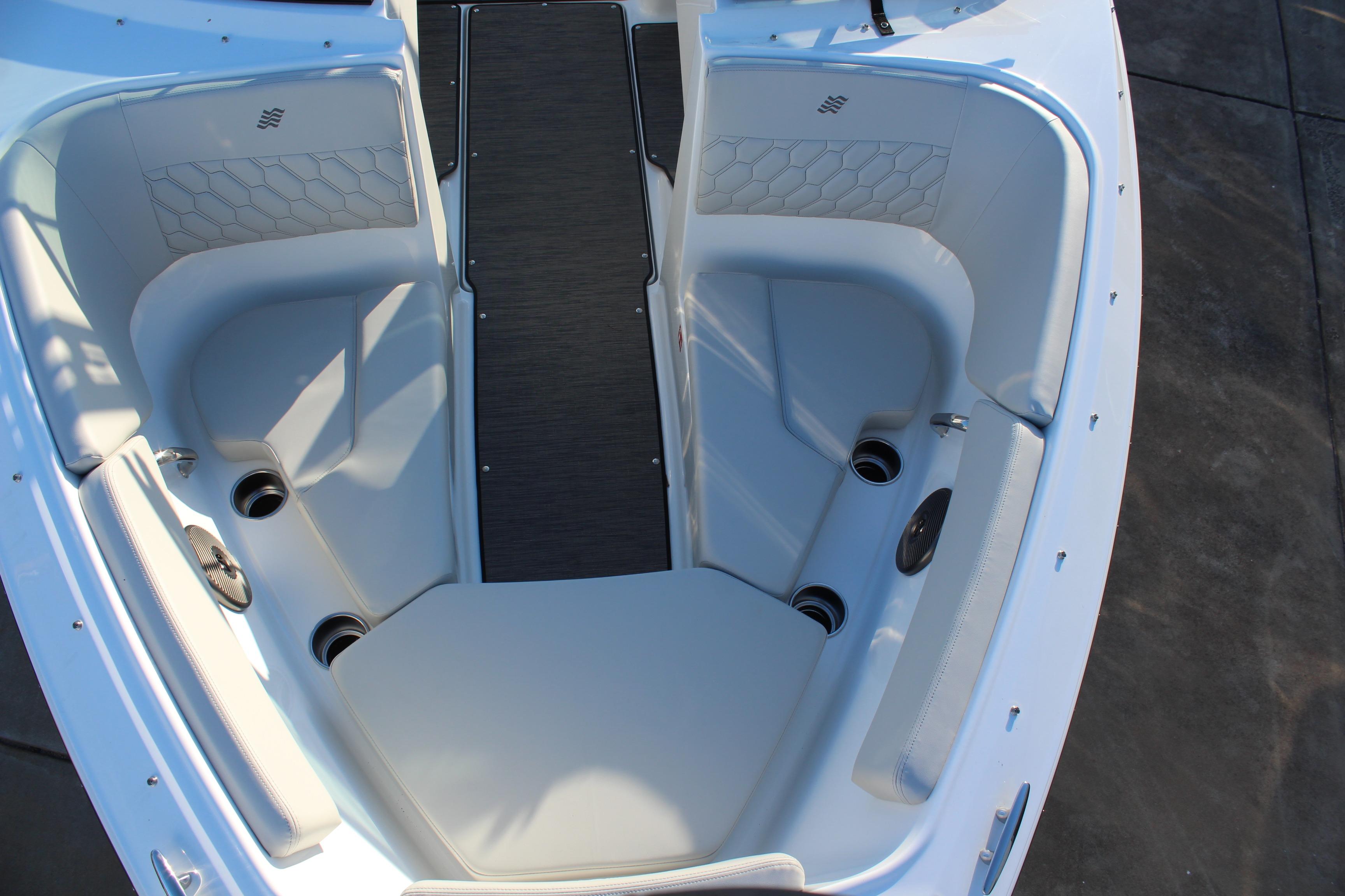 2026 Four Winns H2 Freedom boat interior with gray seating and cup holders.