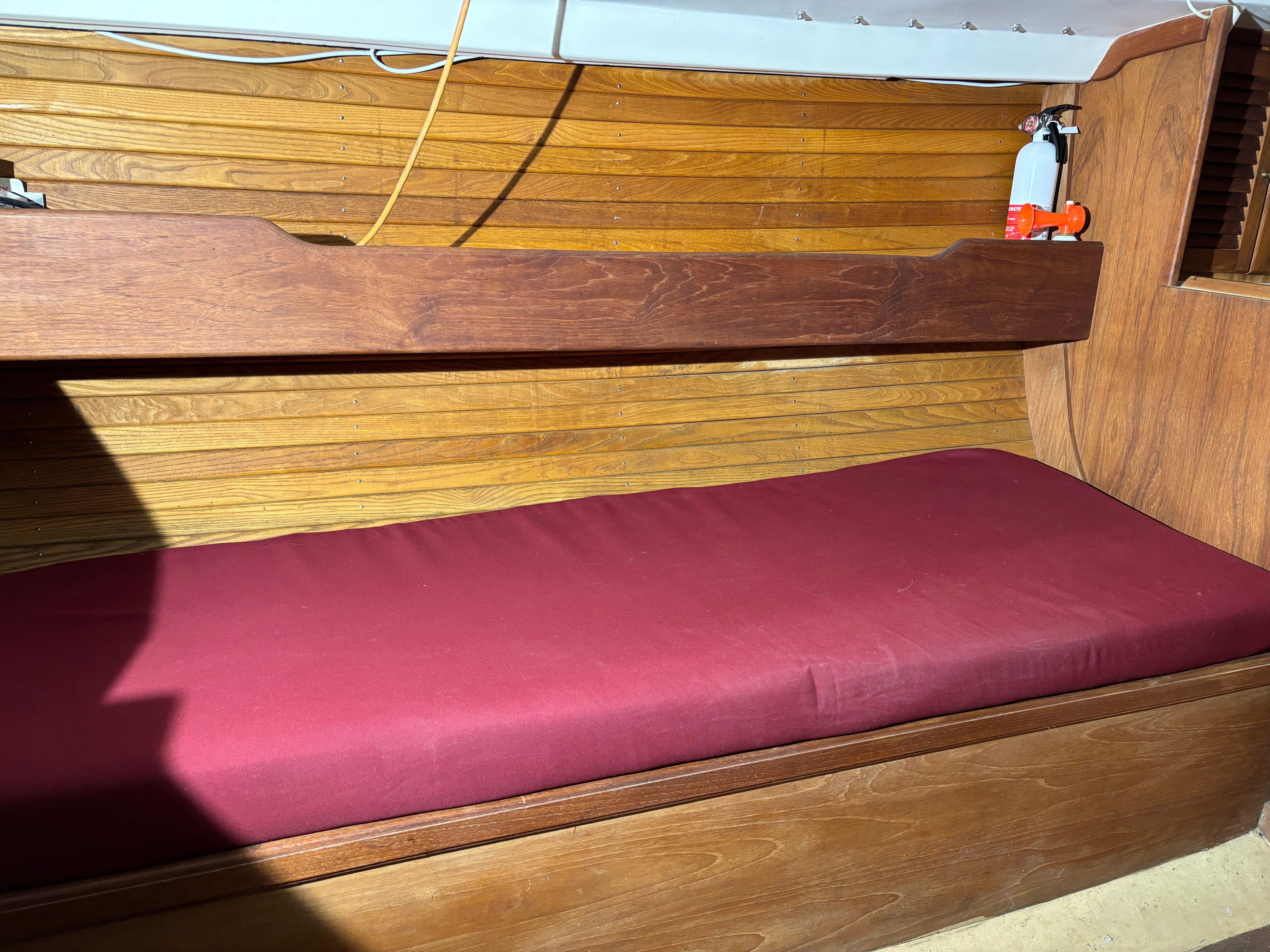 Interior of a 1986 Cape Dory 26 yacht with red cushion.