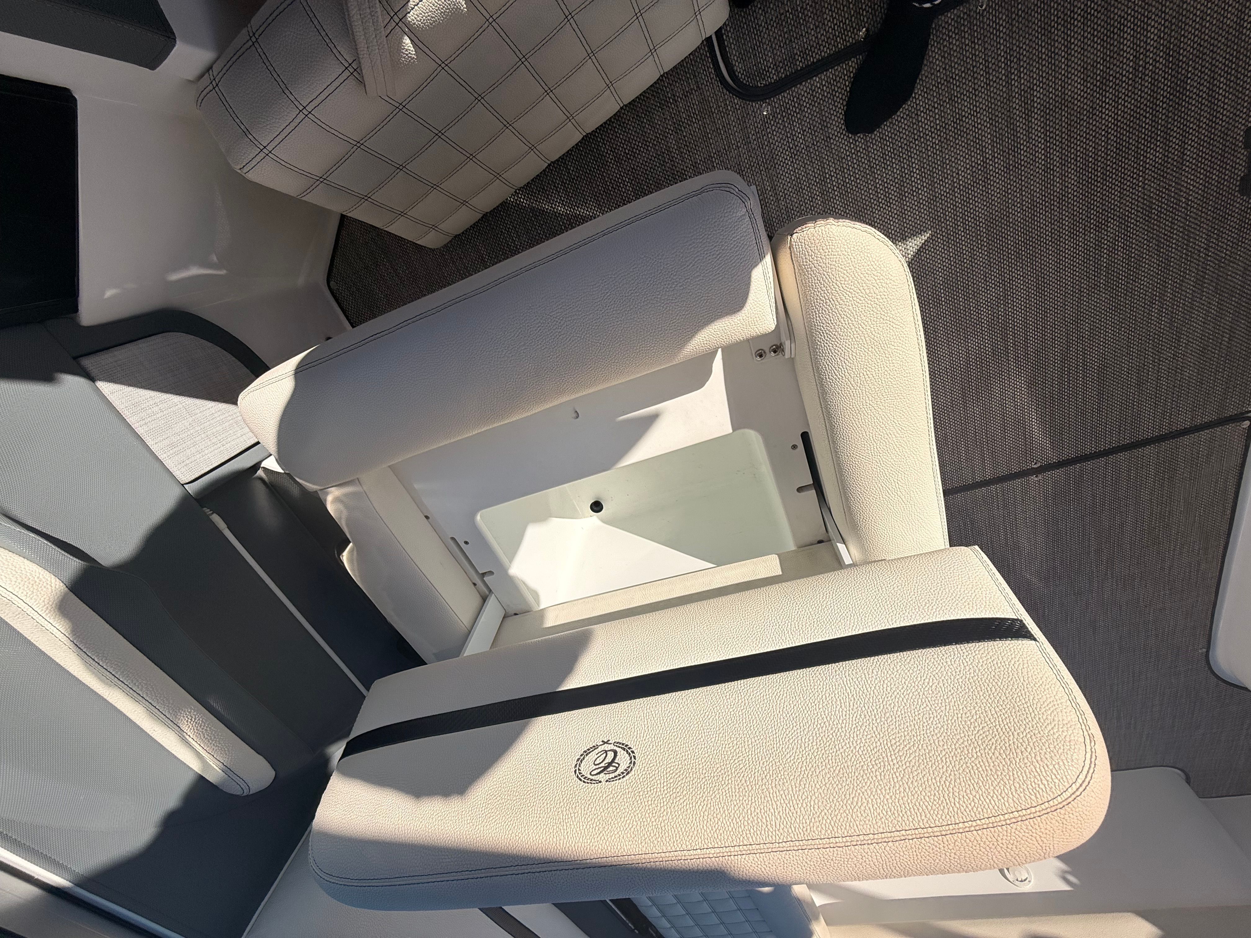 Interior view of a Cobalt R7 Surf boat with beige upholstered seating.
