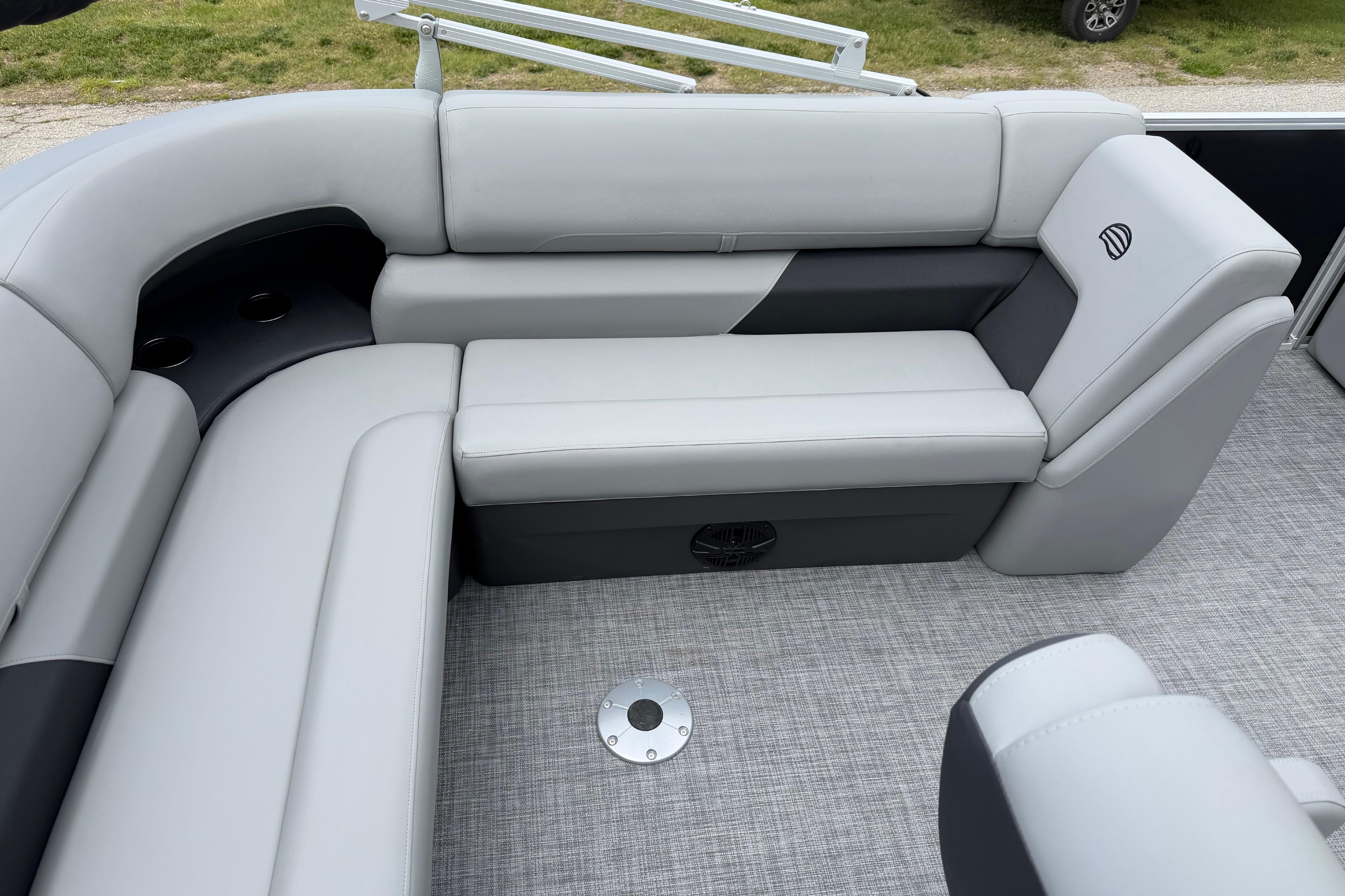 2026 Sun Tracker Party Barge 20 DLX interior with gray seating and cup holders.
