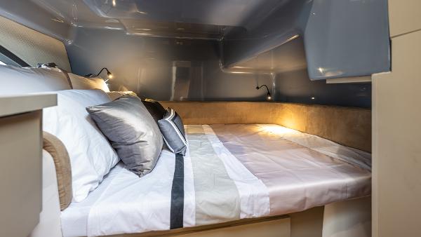 Luxurious interior of 2025 Hanover 415 with cozy bedding and ambient lighting.