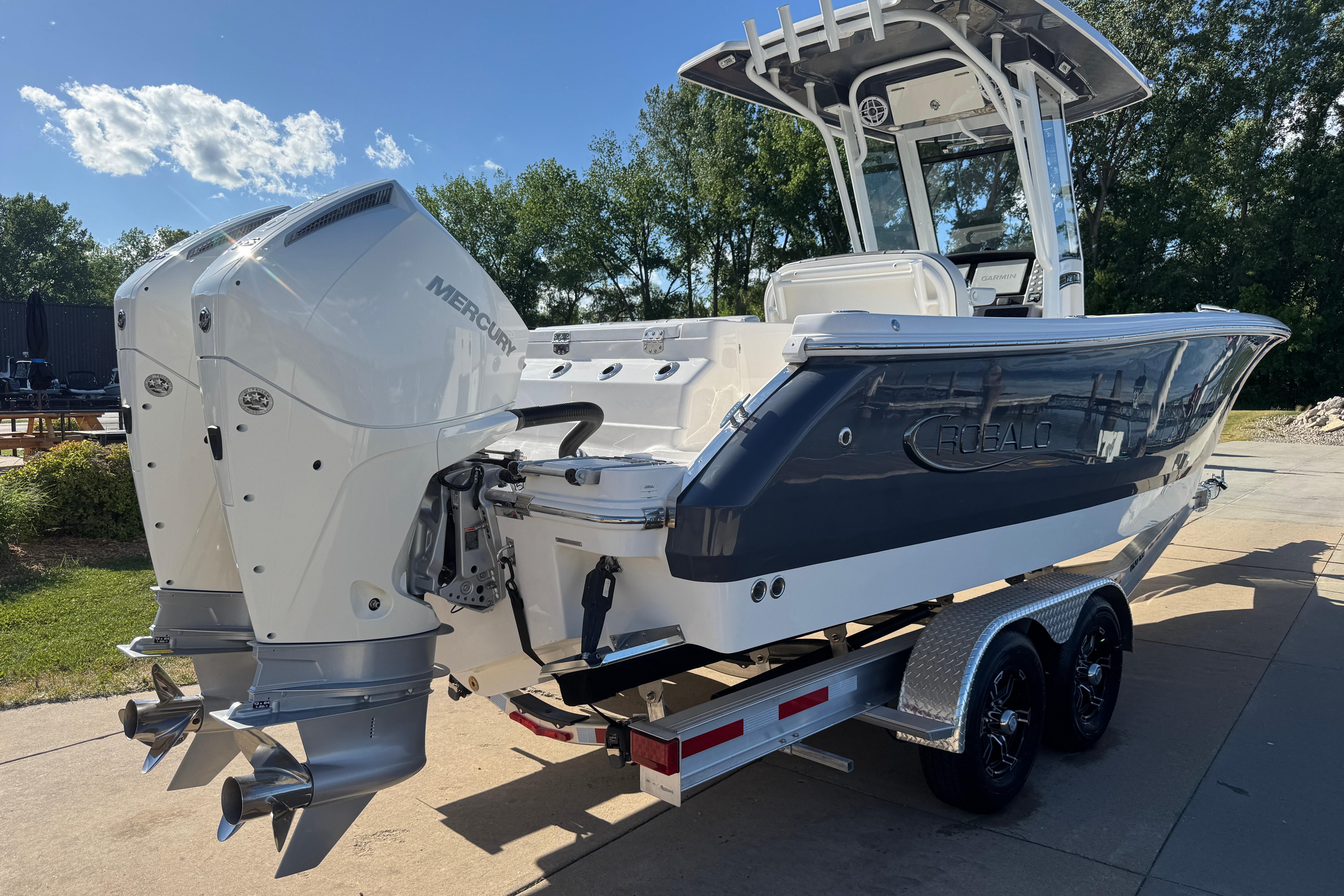 2026 Robalo R250 Center Console boat with dual Mercury engines on a trailer.