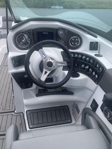 2020 Rinker 29QX BR boat dashboard with steering wheel and control panel.