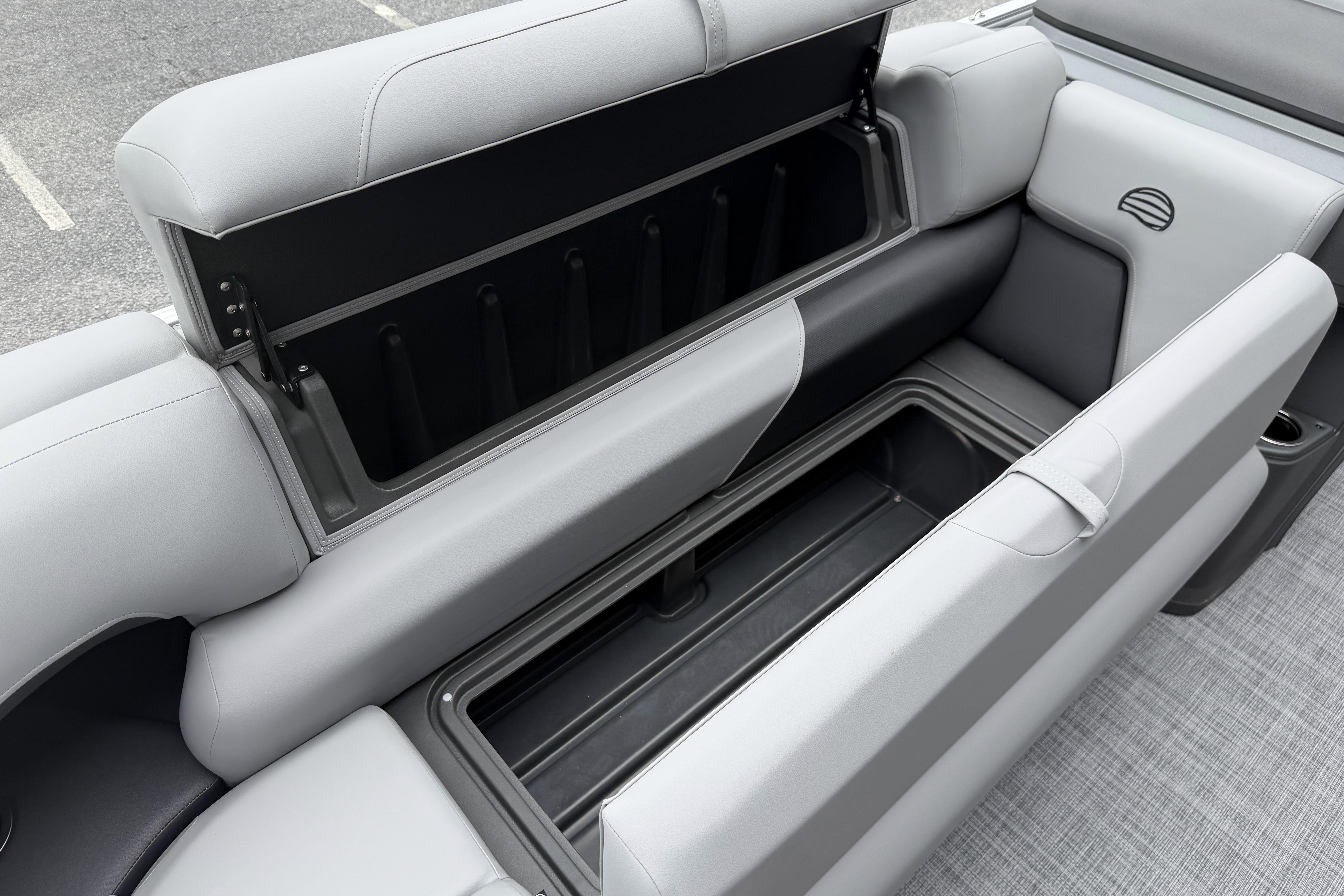 Sun Tracker Party Barge 20 DLX 2026, open storage compartment, gray seating, modern design.