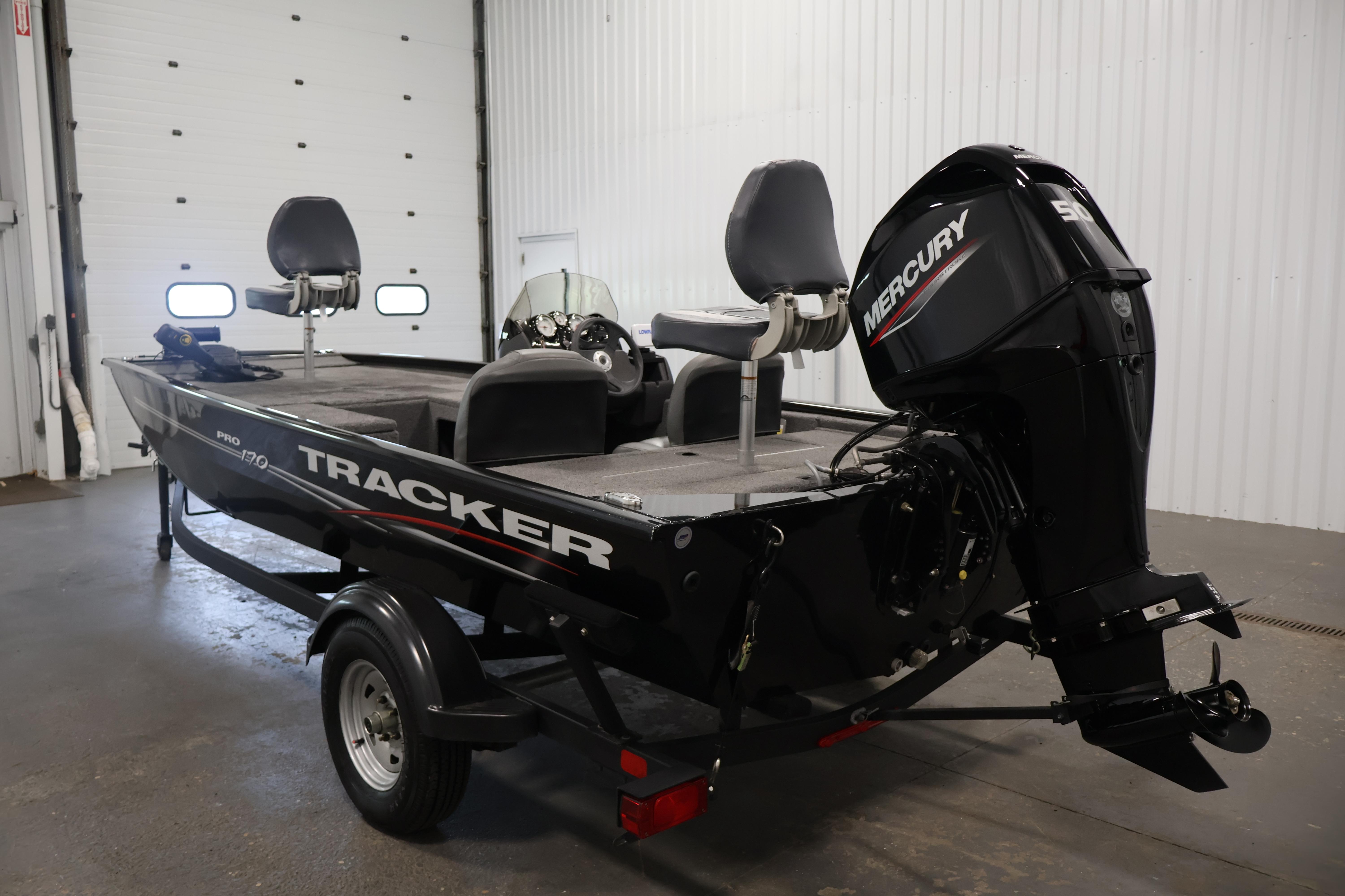 2024 Tracker Pro 170 boat with Mercury engine in a garage setting.