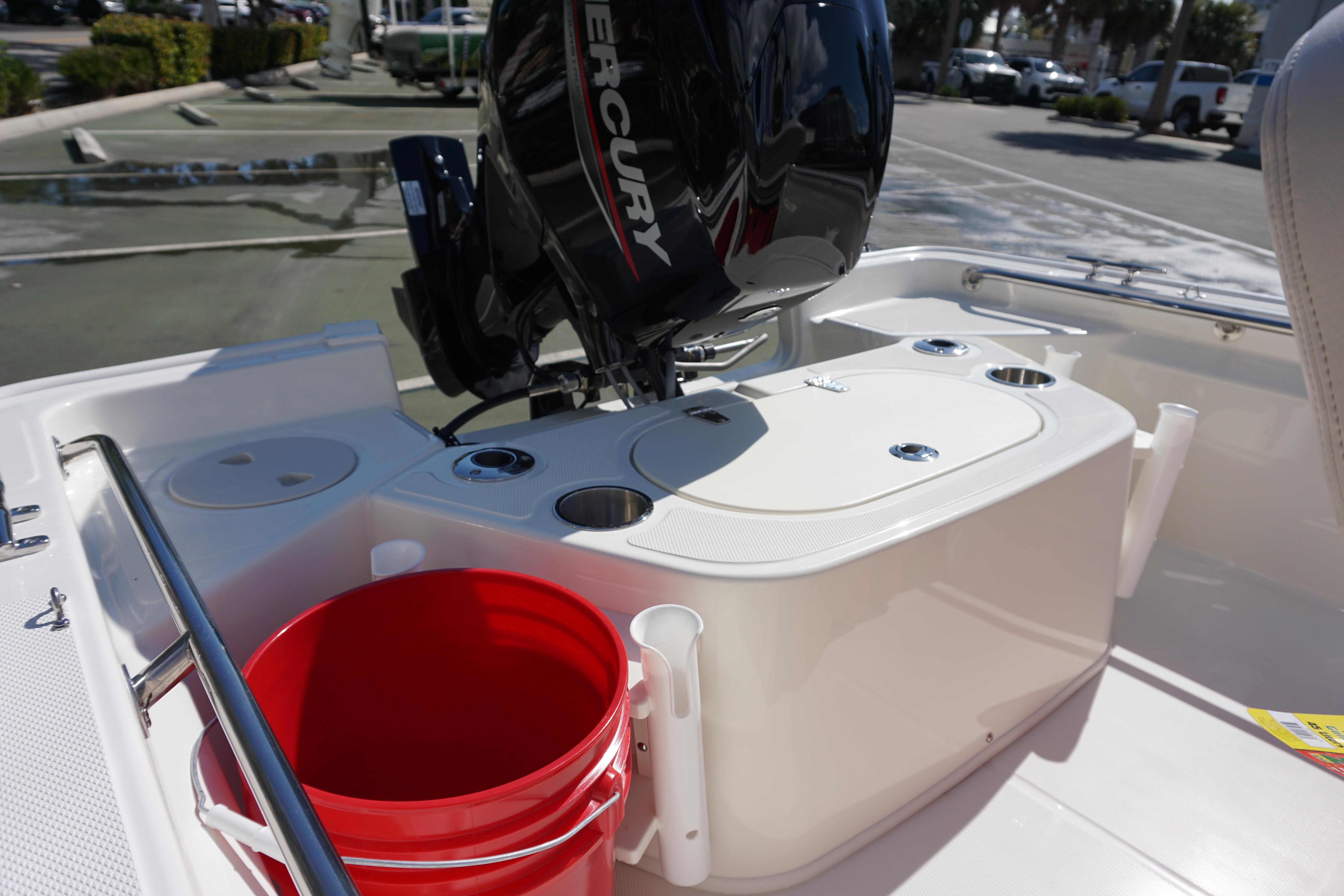 2025 Boston Whaler 150 Montauk boat with Mercury engine and red bucket on deck.