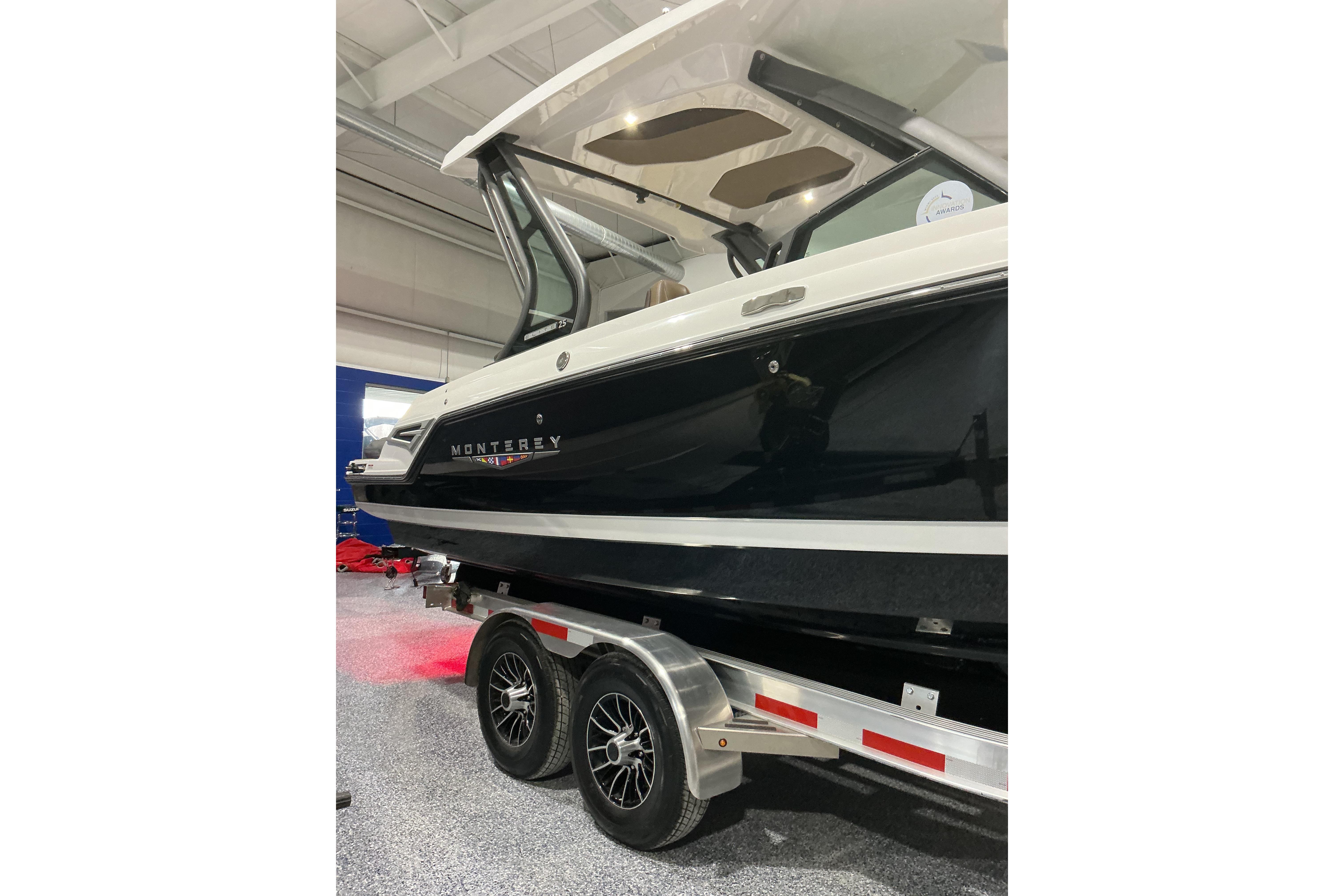 2026 Monterey Elite 25 SD boat on trailer in showroom.