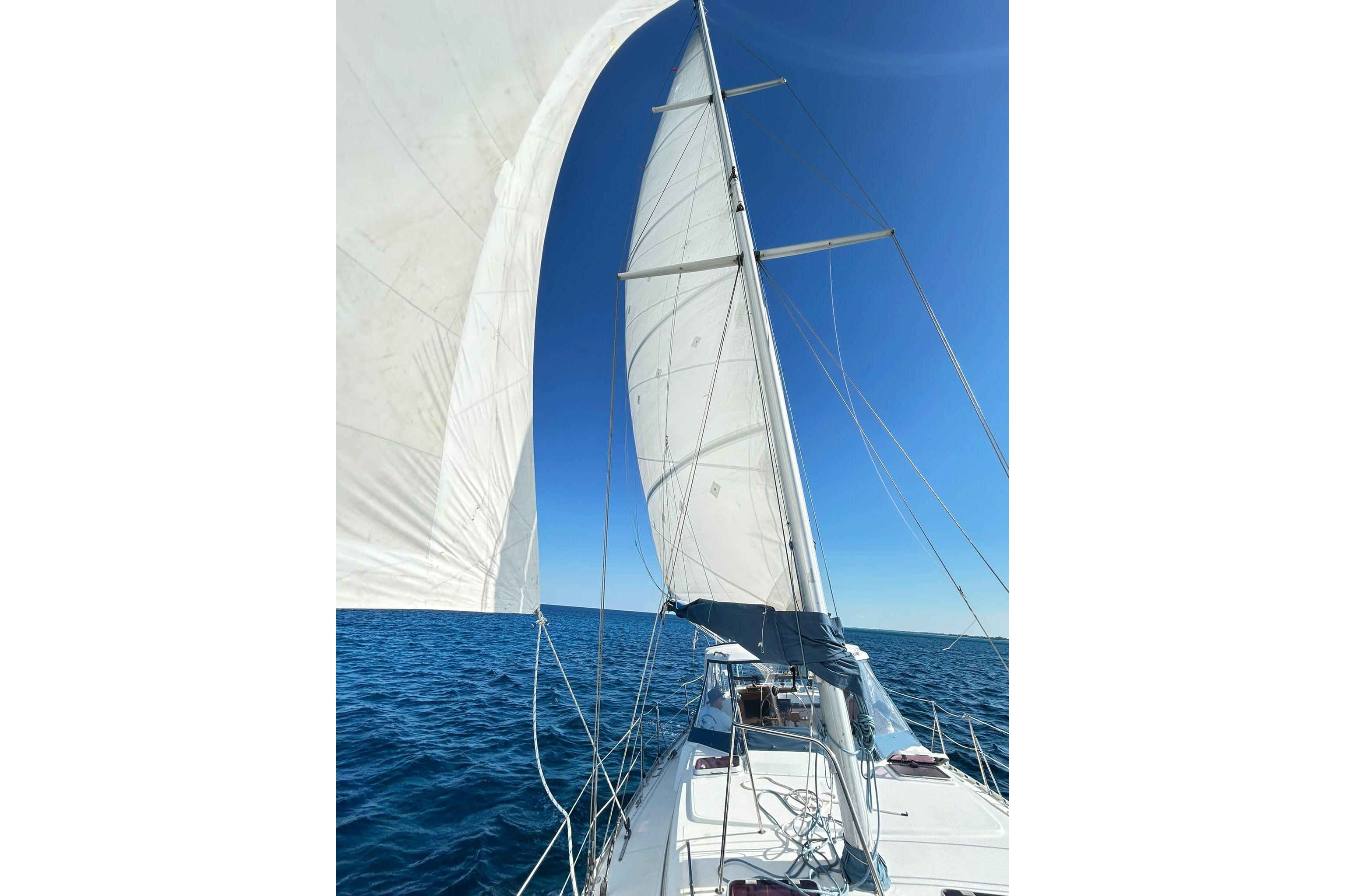 1987 Gulfstar CSY 50 Pilot House sailing on open sea under clear blue sky.