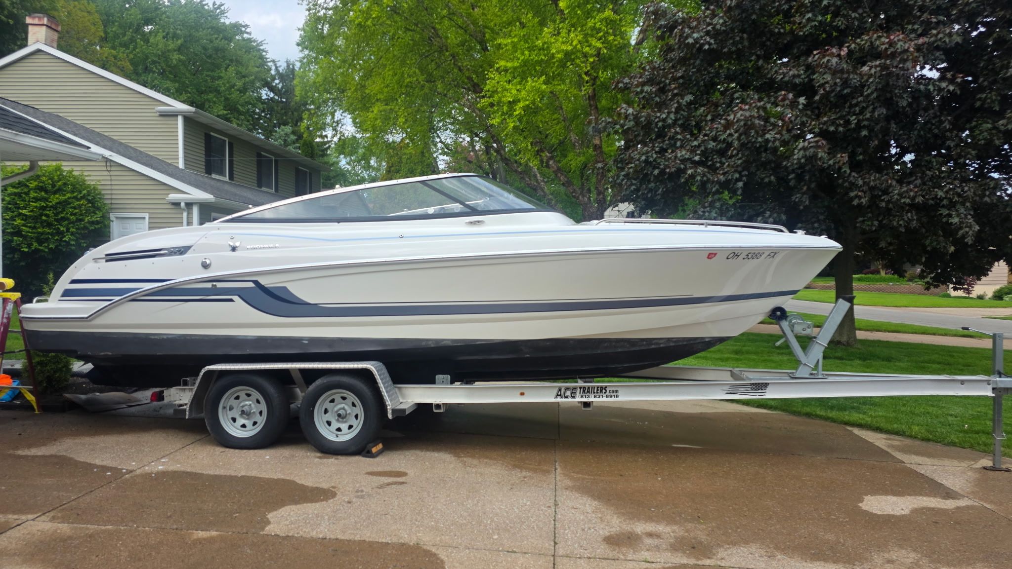 2019 Formula 240 boat on trailer in residential area.