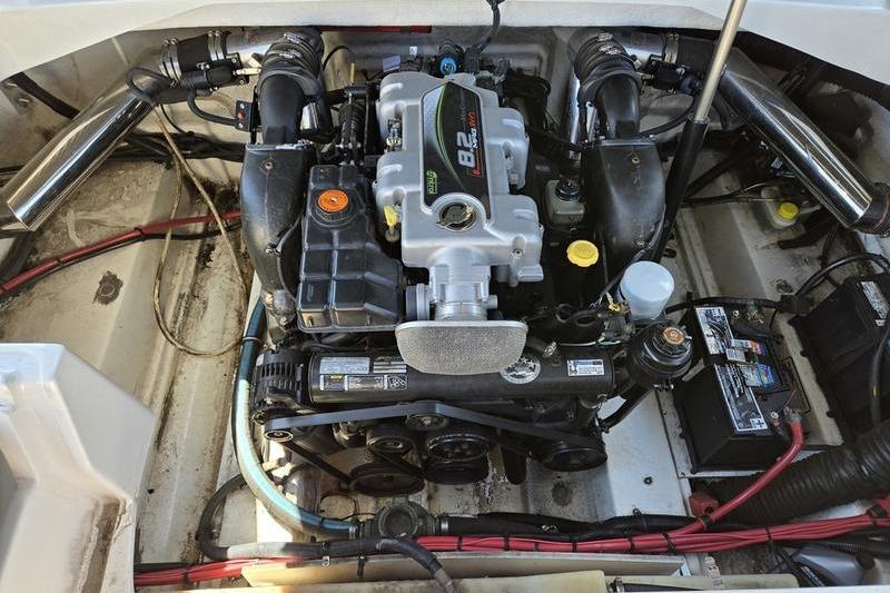 Engine compartment of a 2011 Sea Ray 300 Sundeck boat, showcasing detailed components.